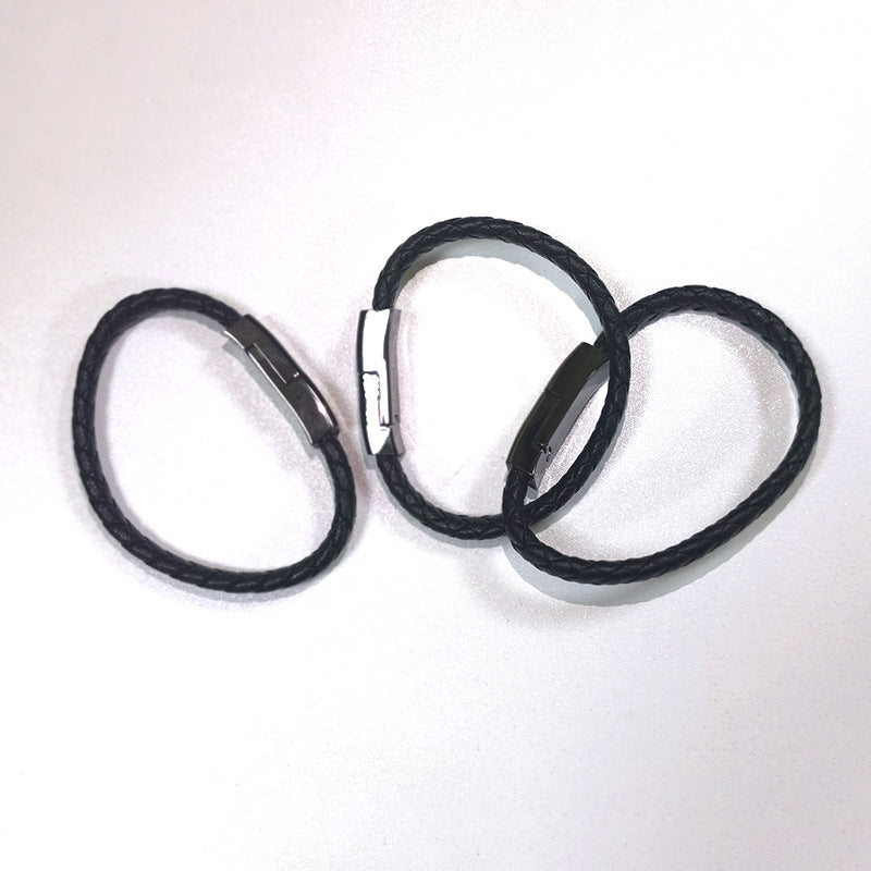 Three black hair ties on a white background