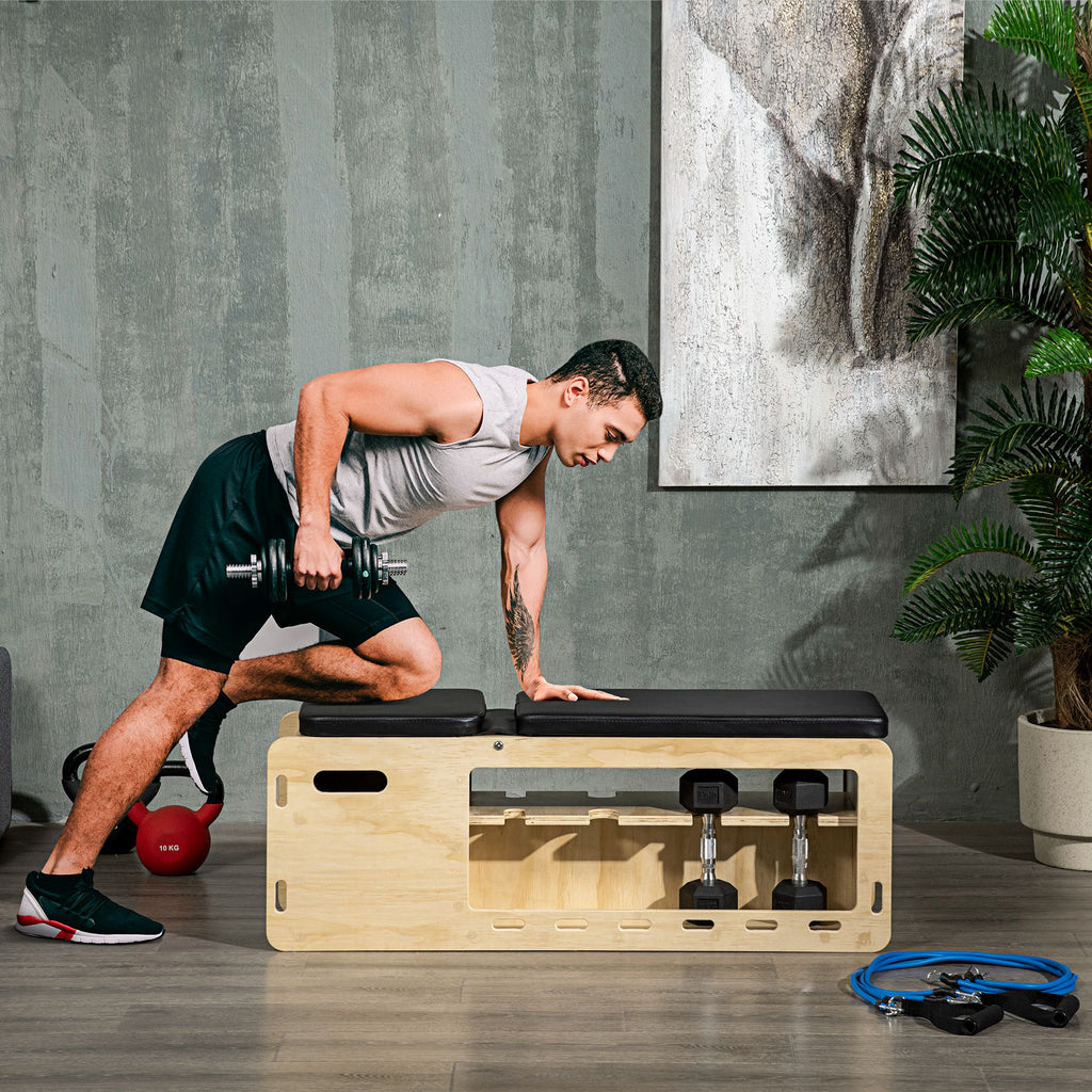 Man exercising with a wooden box and dumbbells in a home setting.