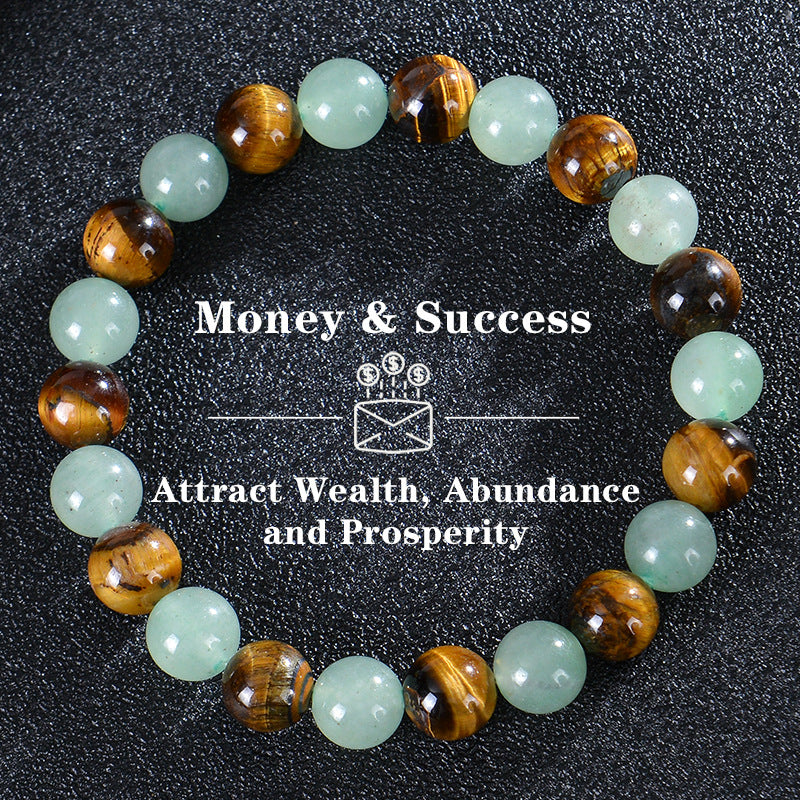 Bracelet with green and brown beads on a black background, featuring text about money, success, wealth, abundance, and prosperity.