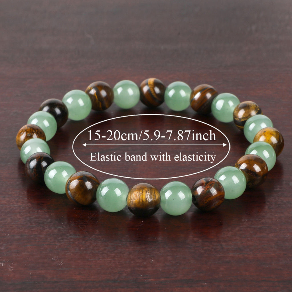 Beaded bracelet with green and brown beads on a dark wooden surface