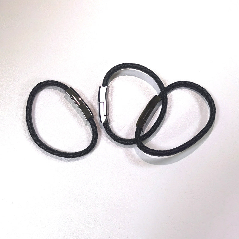 Three black hair ties on a white background