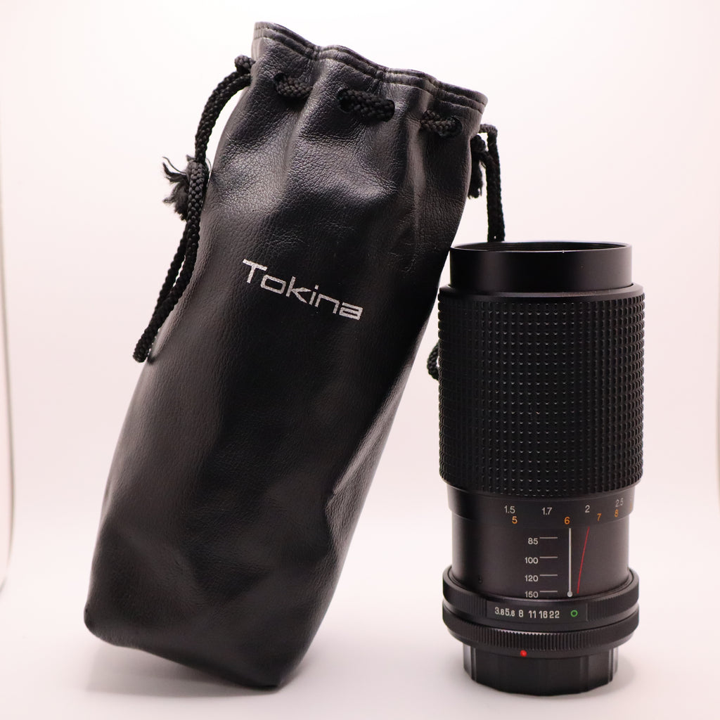 Camera lens with Tokina pouch on a white background