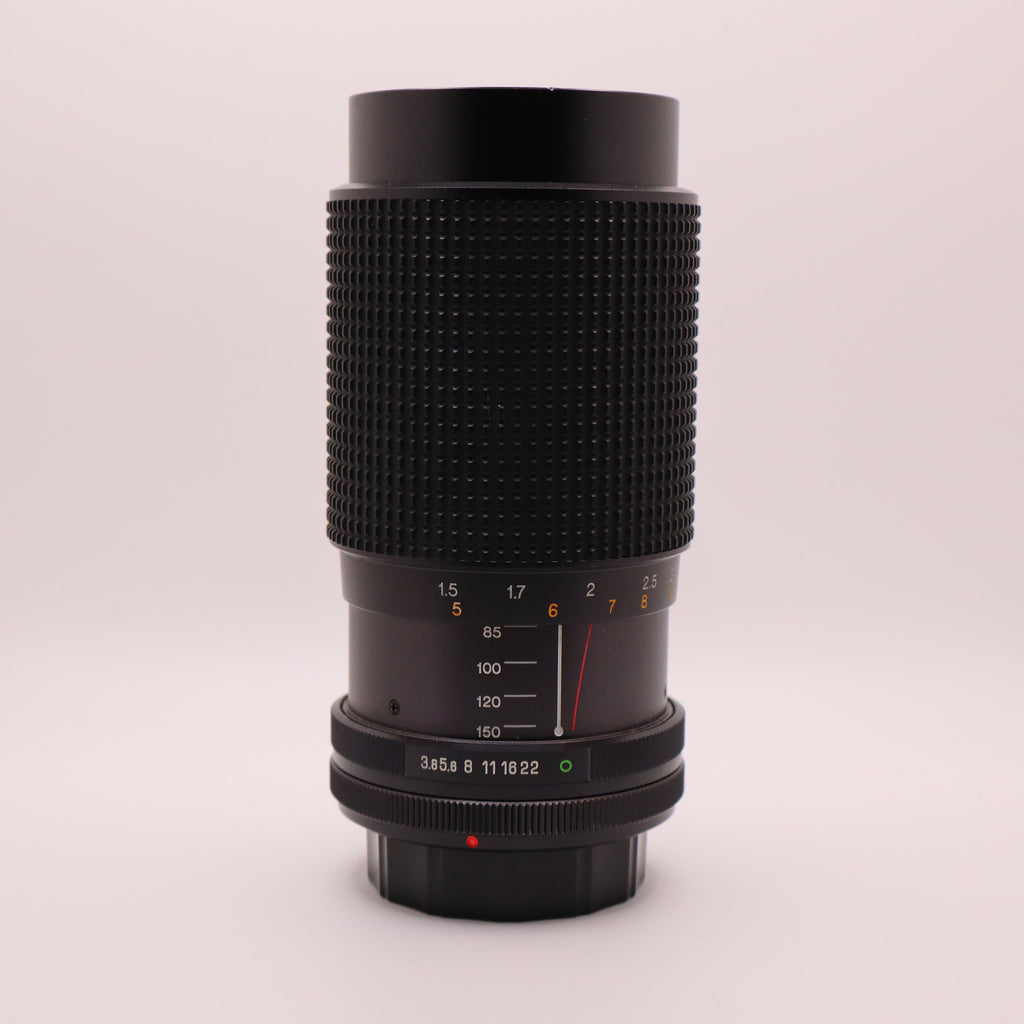 Camera lens with focus scale on a light gray background
