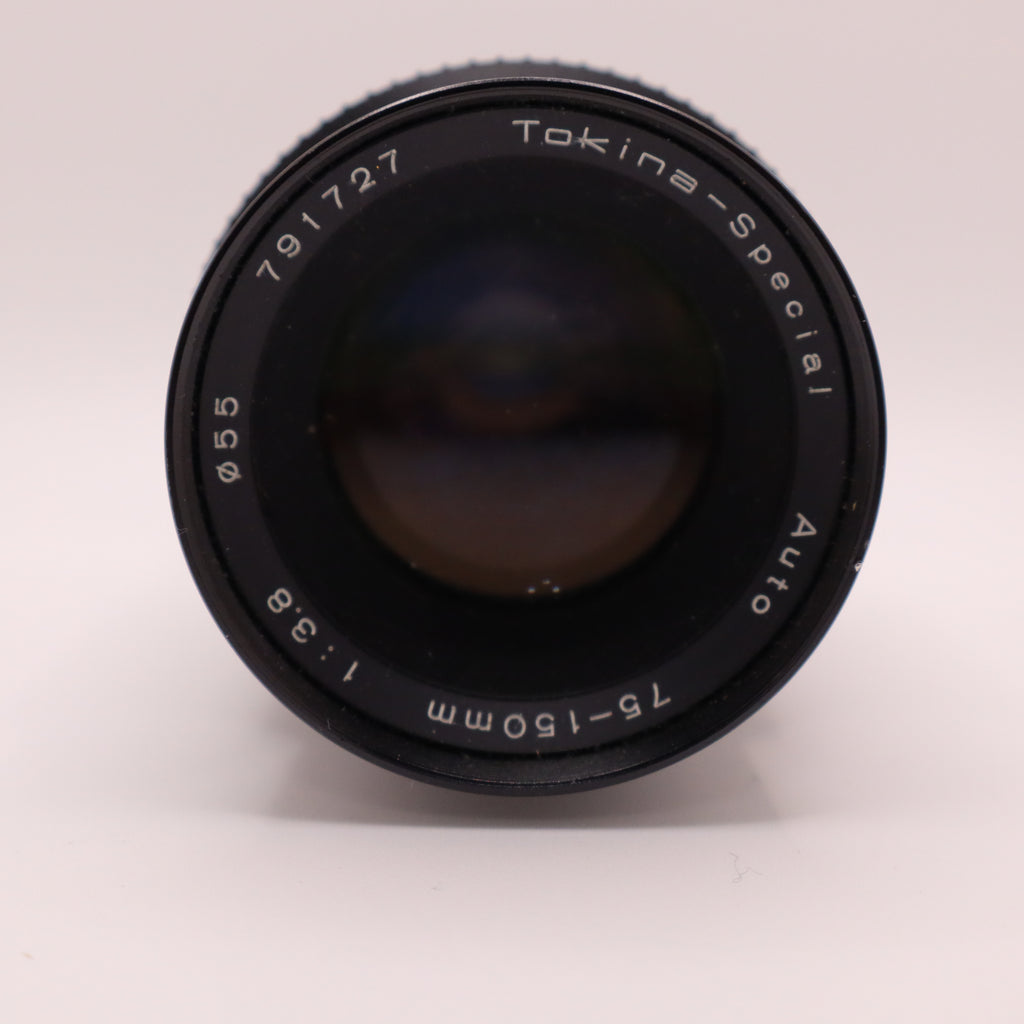Camera lens with 'Tokina Special' branding on a light gray background