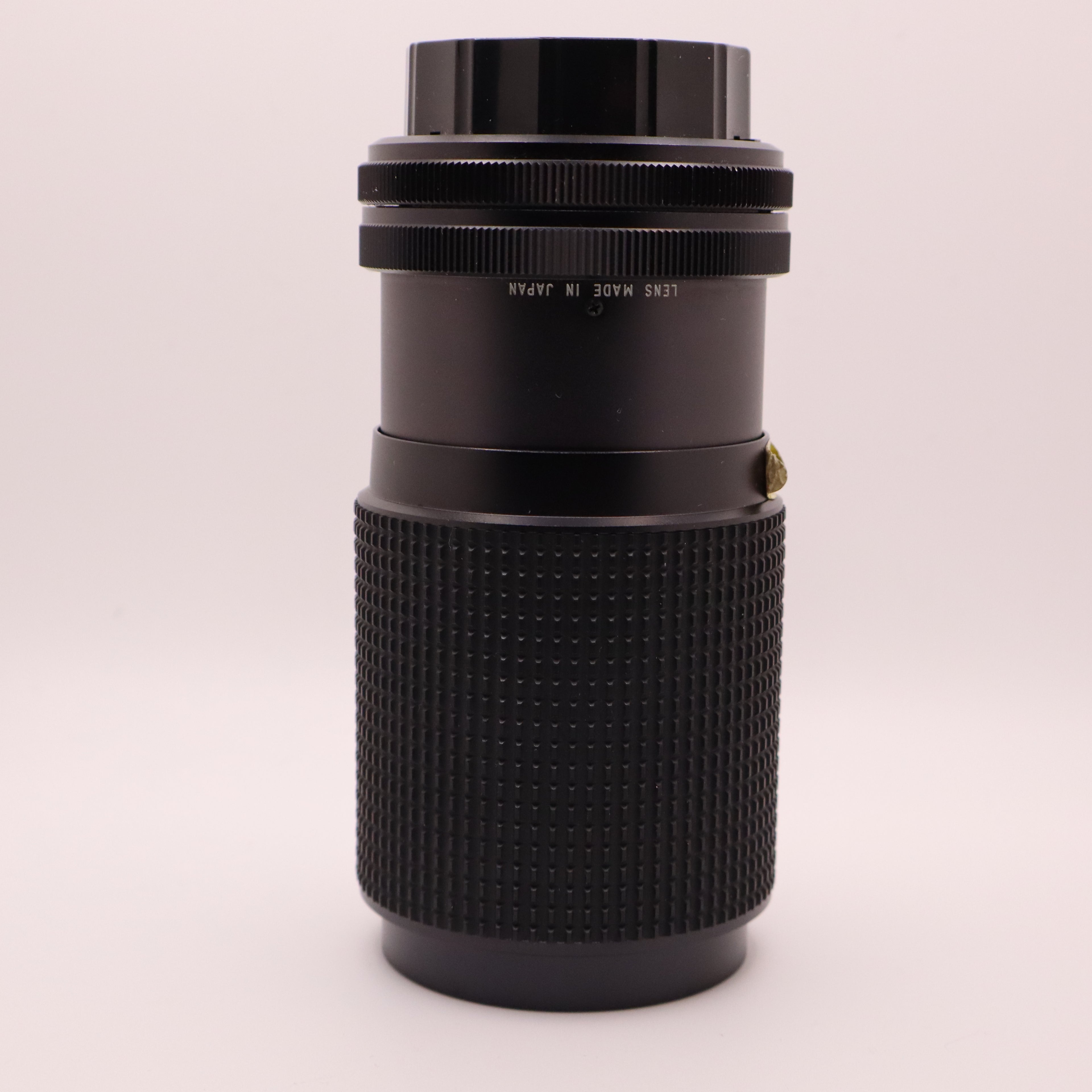 Black camera lens on a white background