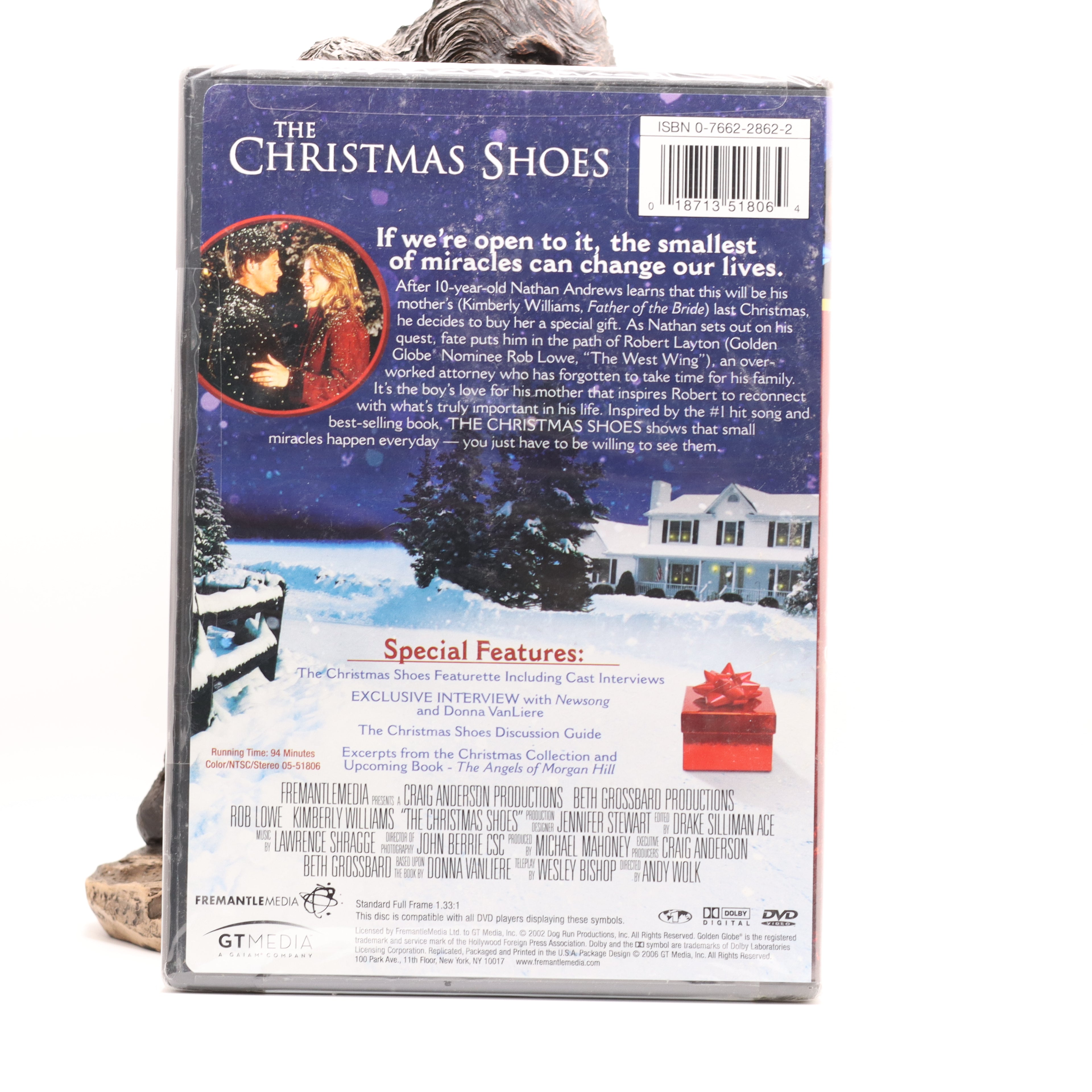 Back cover of a DVD titled 'The Christmas Shoes' with a snowy scene and text.