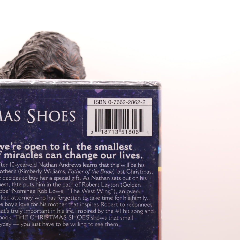 Back cover of a book titled 'The Christmas Shoes' with a barcode and text.