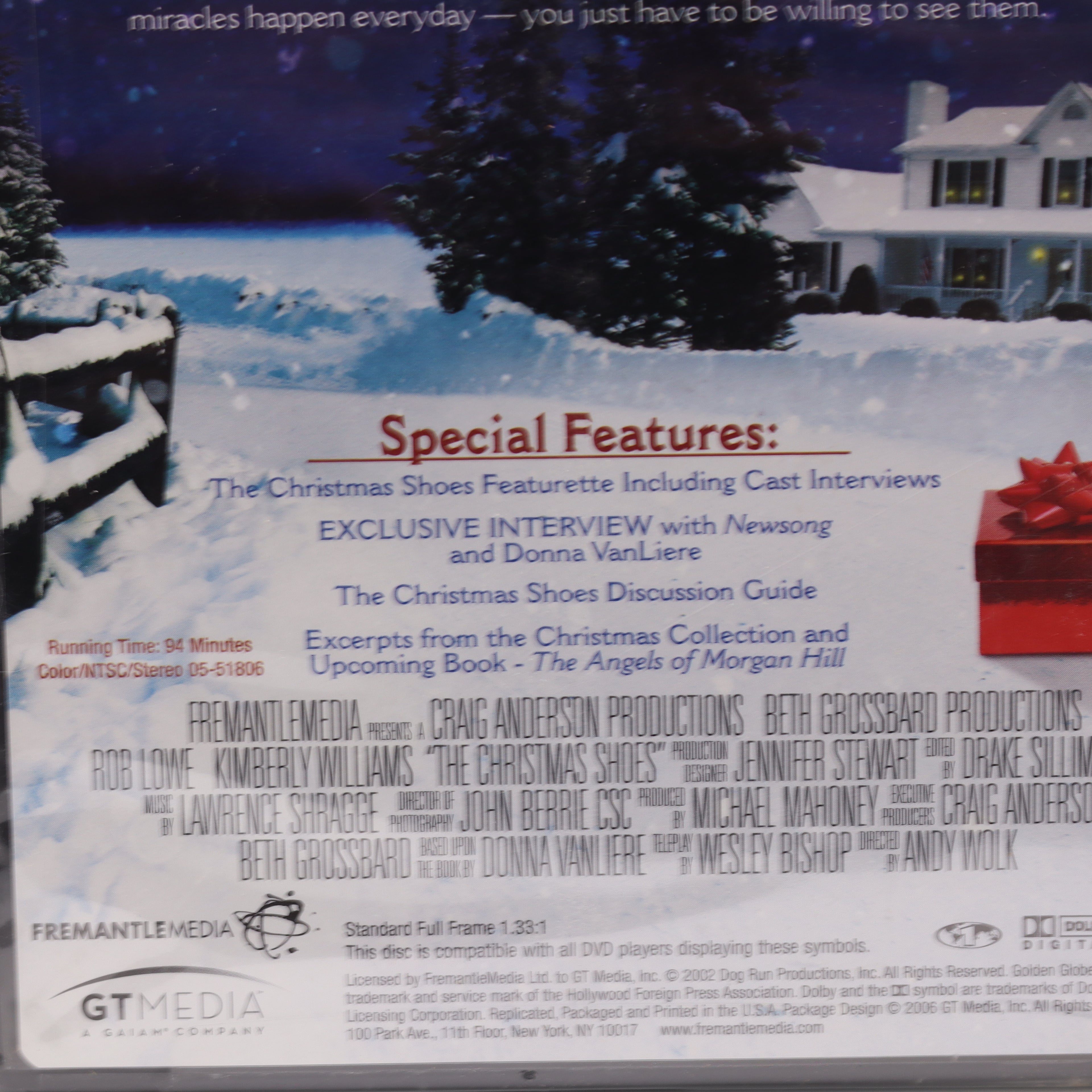 Back cover of a DVD with a snowy landscape and house, featuring special features text.
