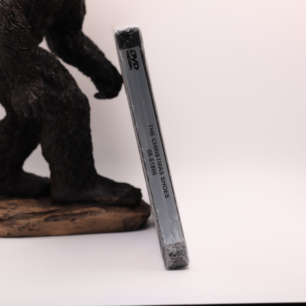 dvd case with text next to bigfoot figurine on a white background