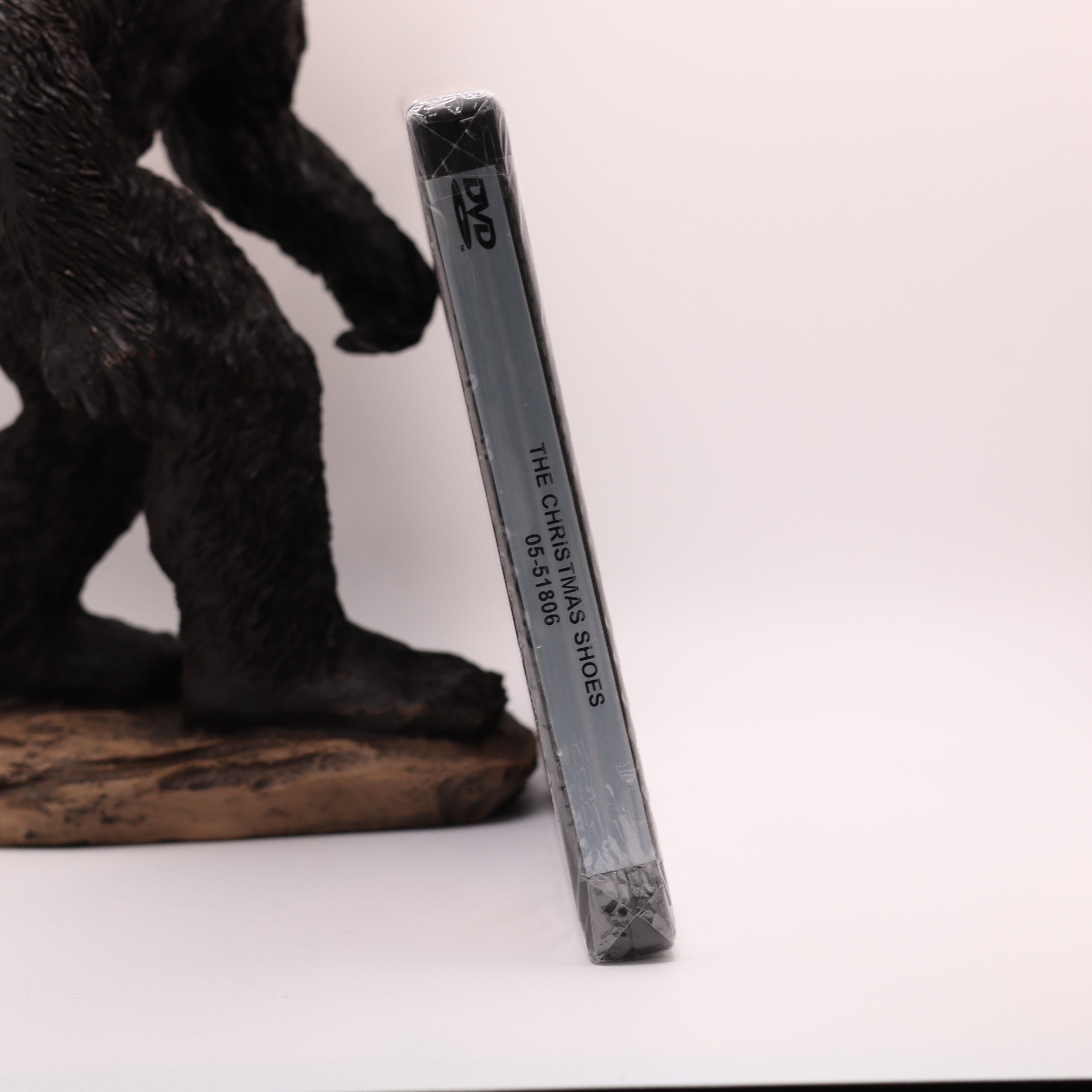 dvd case with text next to bigfoot figurine on a white background