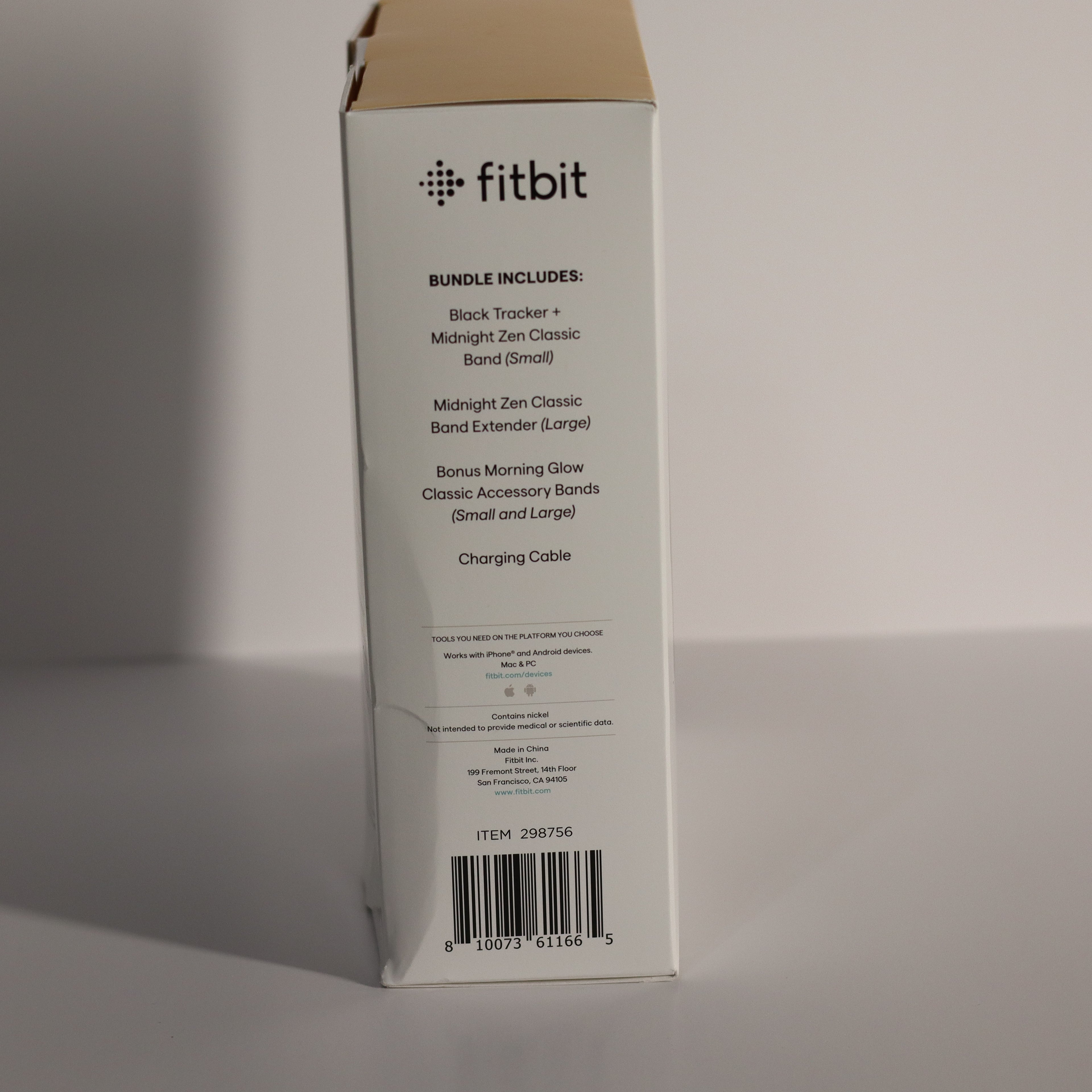 Fitbit product packaging box with item details on a gray background