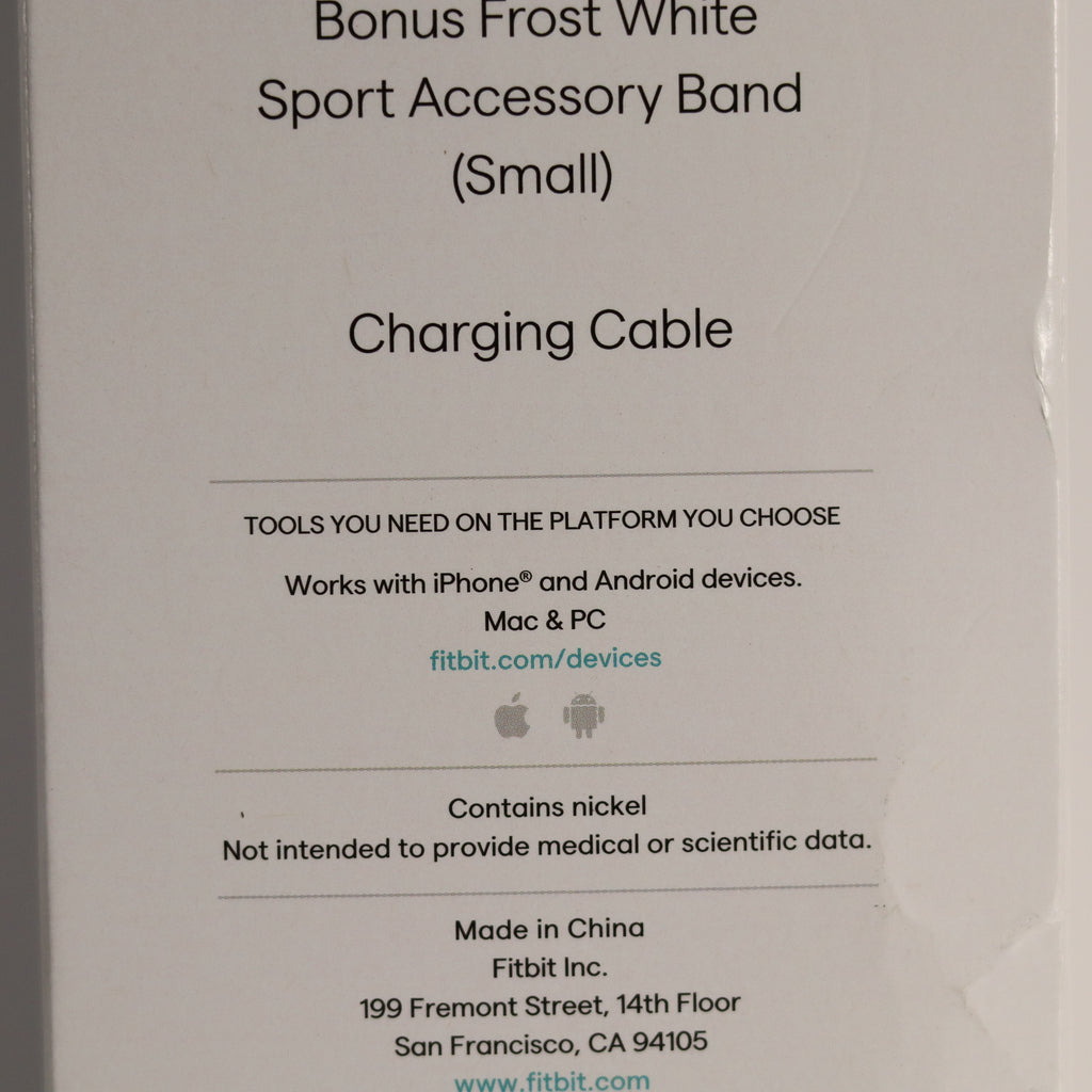 Fitbit accessory packaging with text about a bonus Frost White Sport Accessory Band and charging cable.