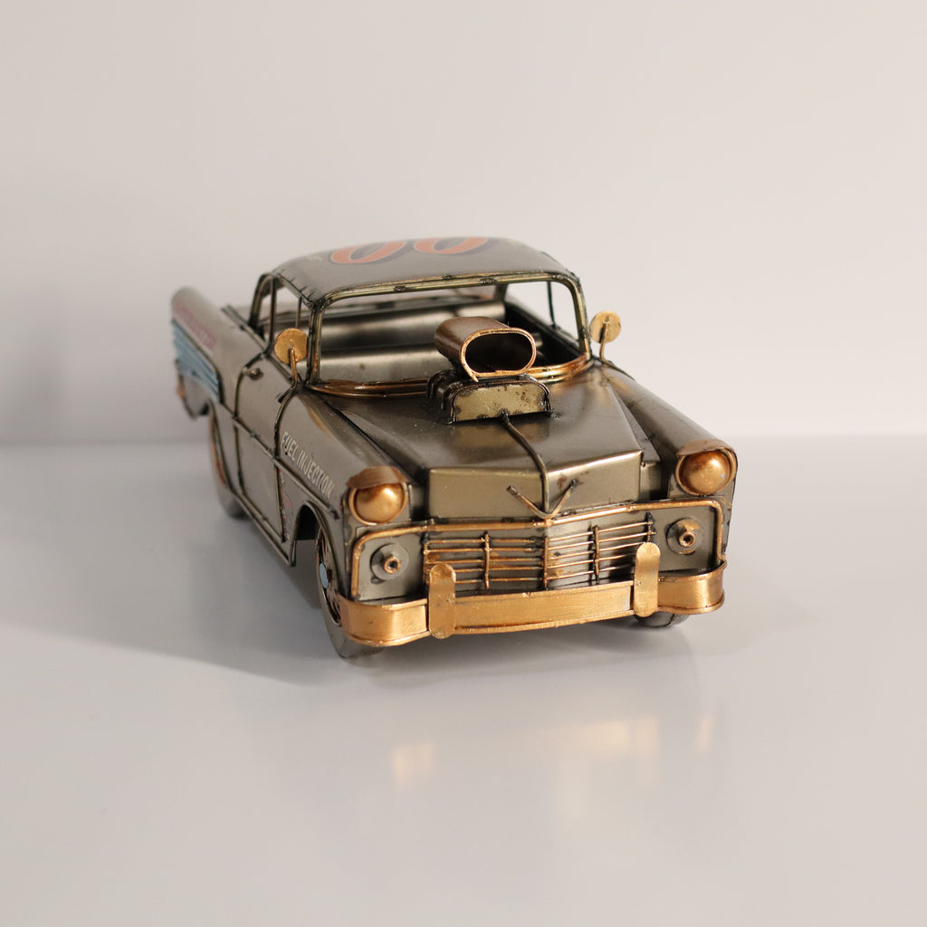 Metallic model of a classic car on a white background