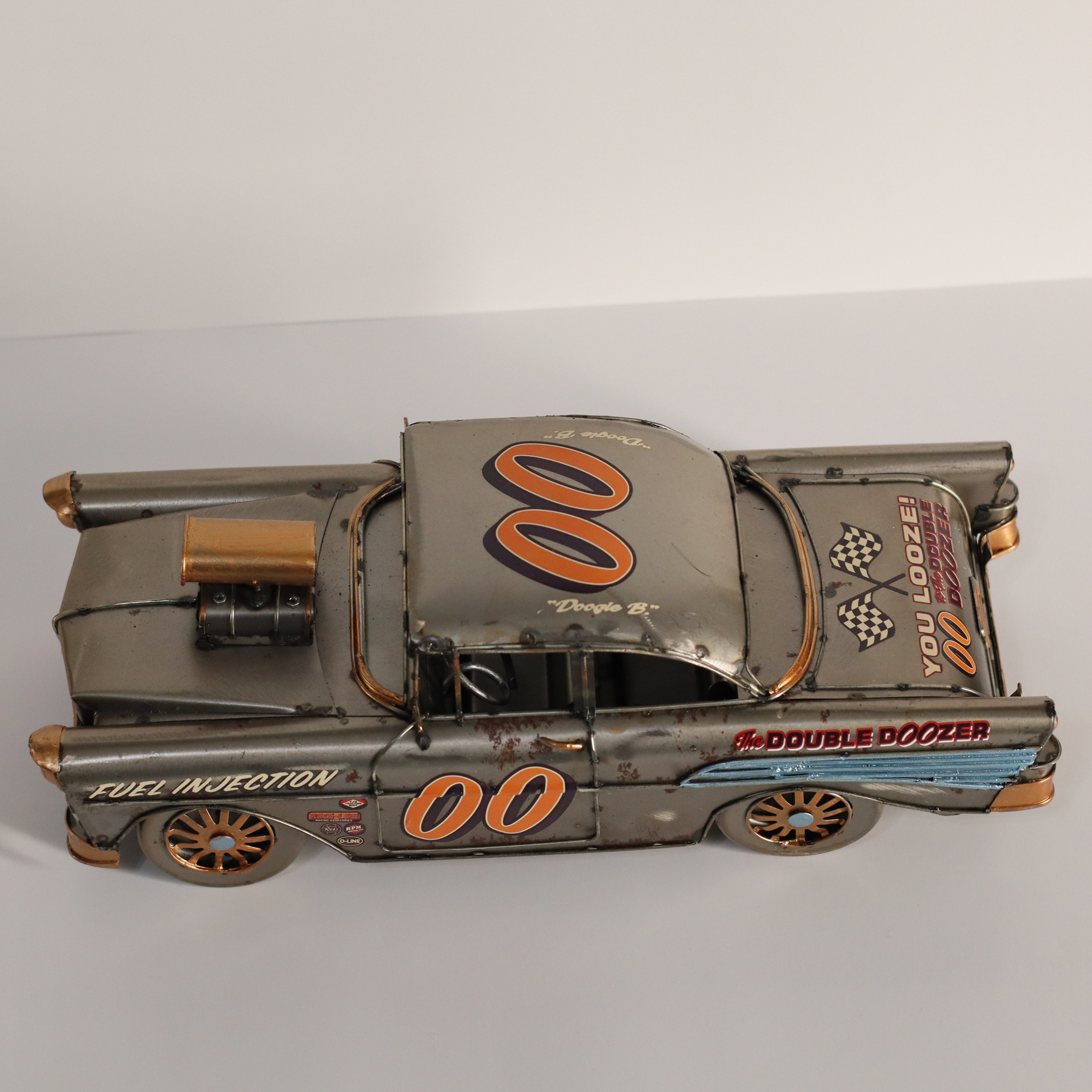 Model of a vintage race car with 'Double Dozer' branding on a gray background