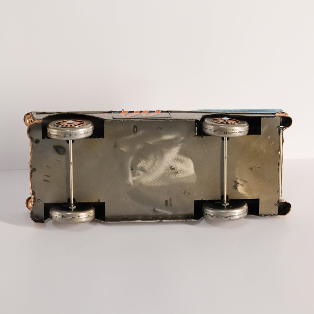 Metallic object with cylindrical components on a white background