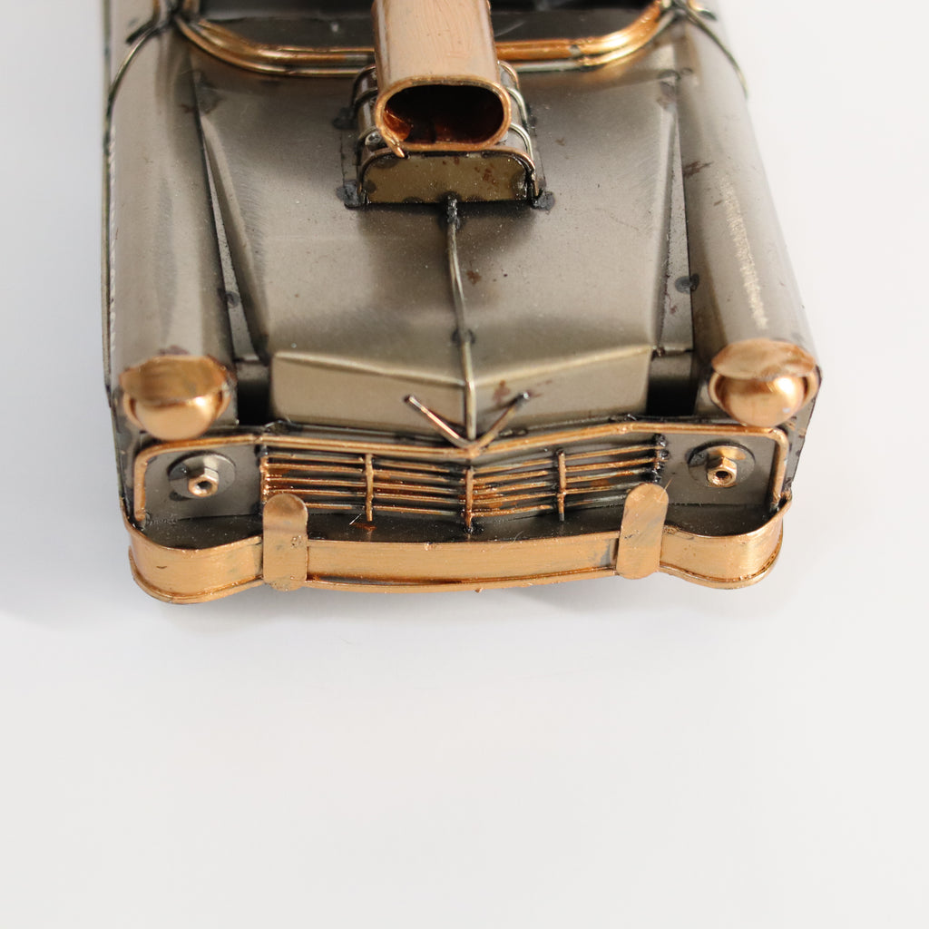 Metallic model of a vintage car on a white background