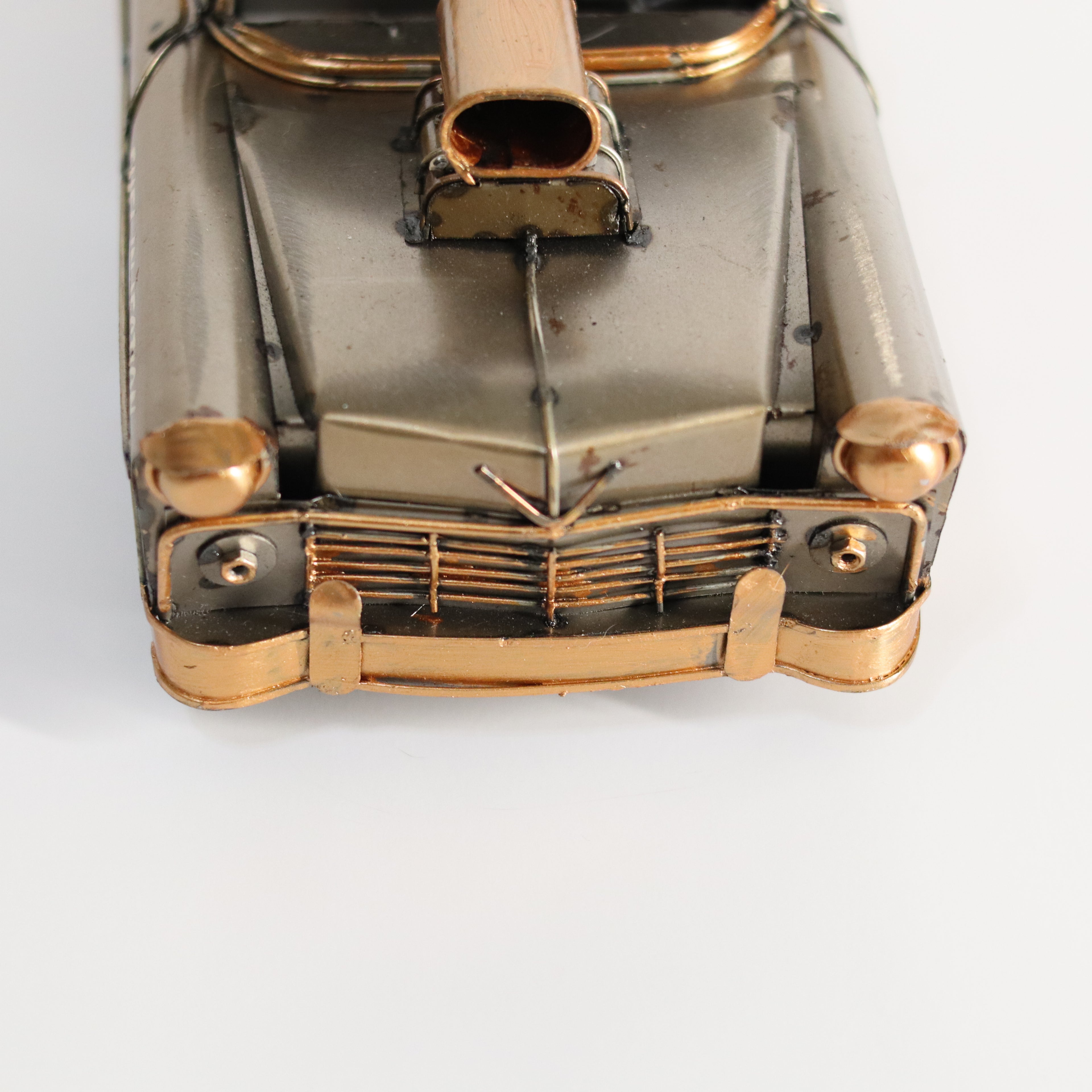 Metallic model of a vintage car on a white background
