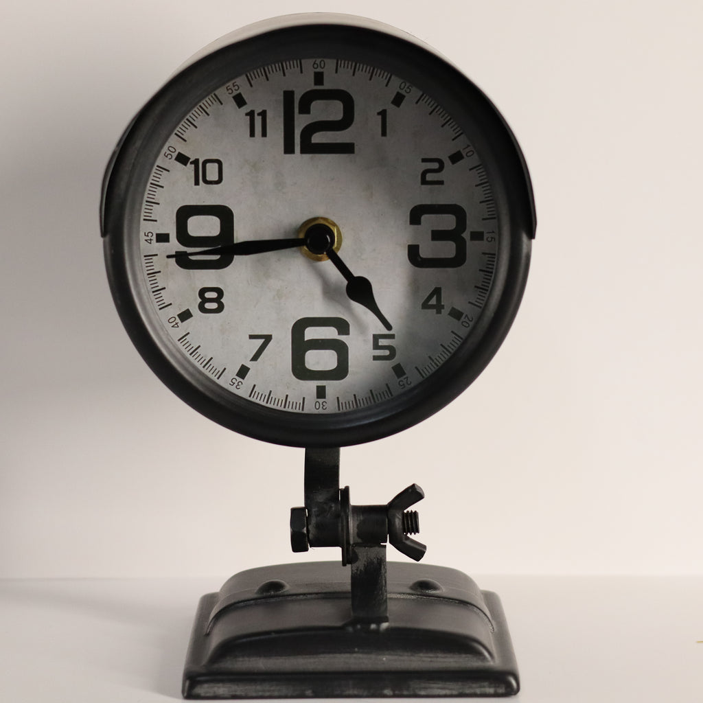 Vintage-style clock with black frame and white face on a light gray background