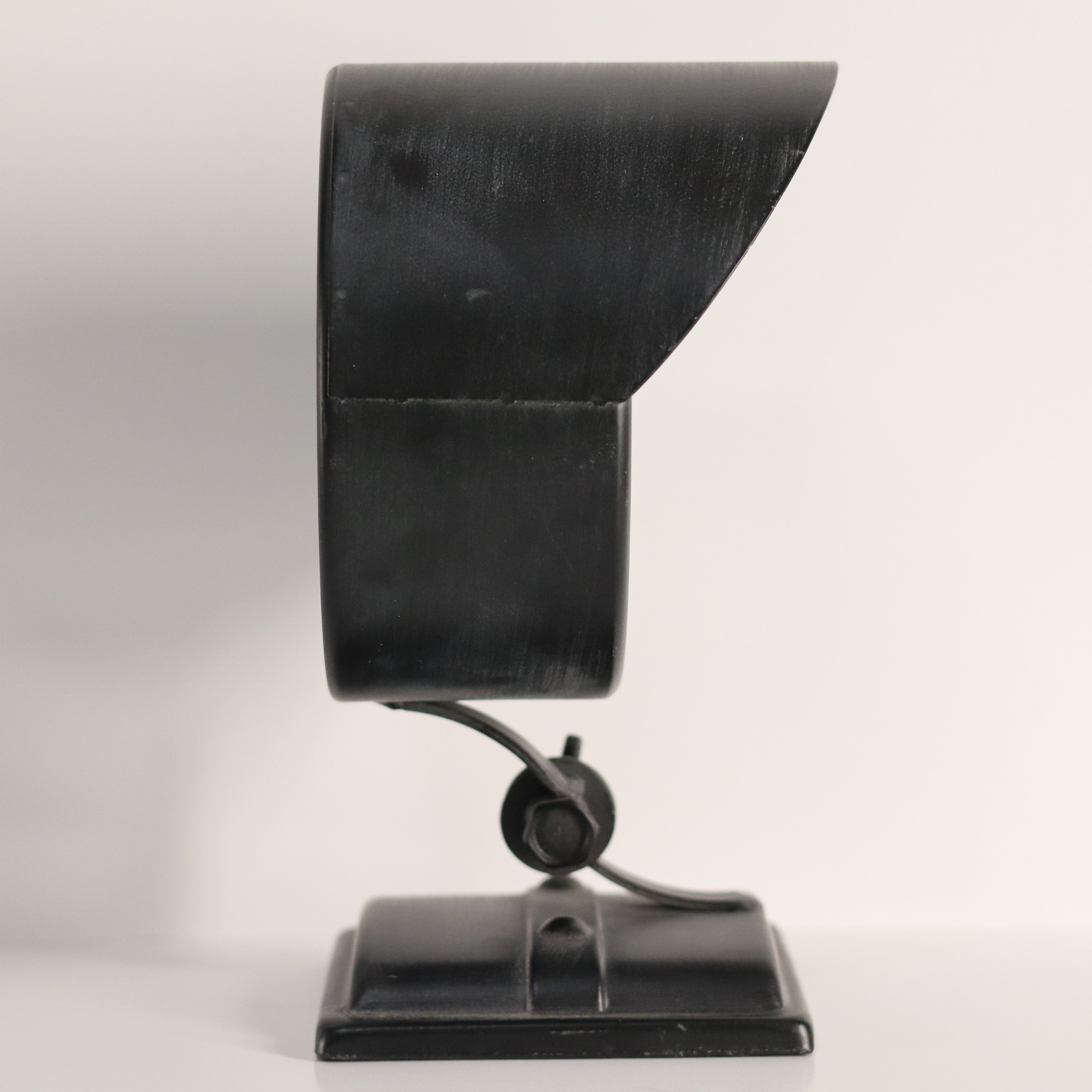 Black metal stand with a curved top on a white background