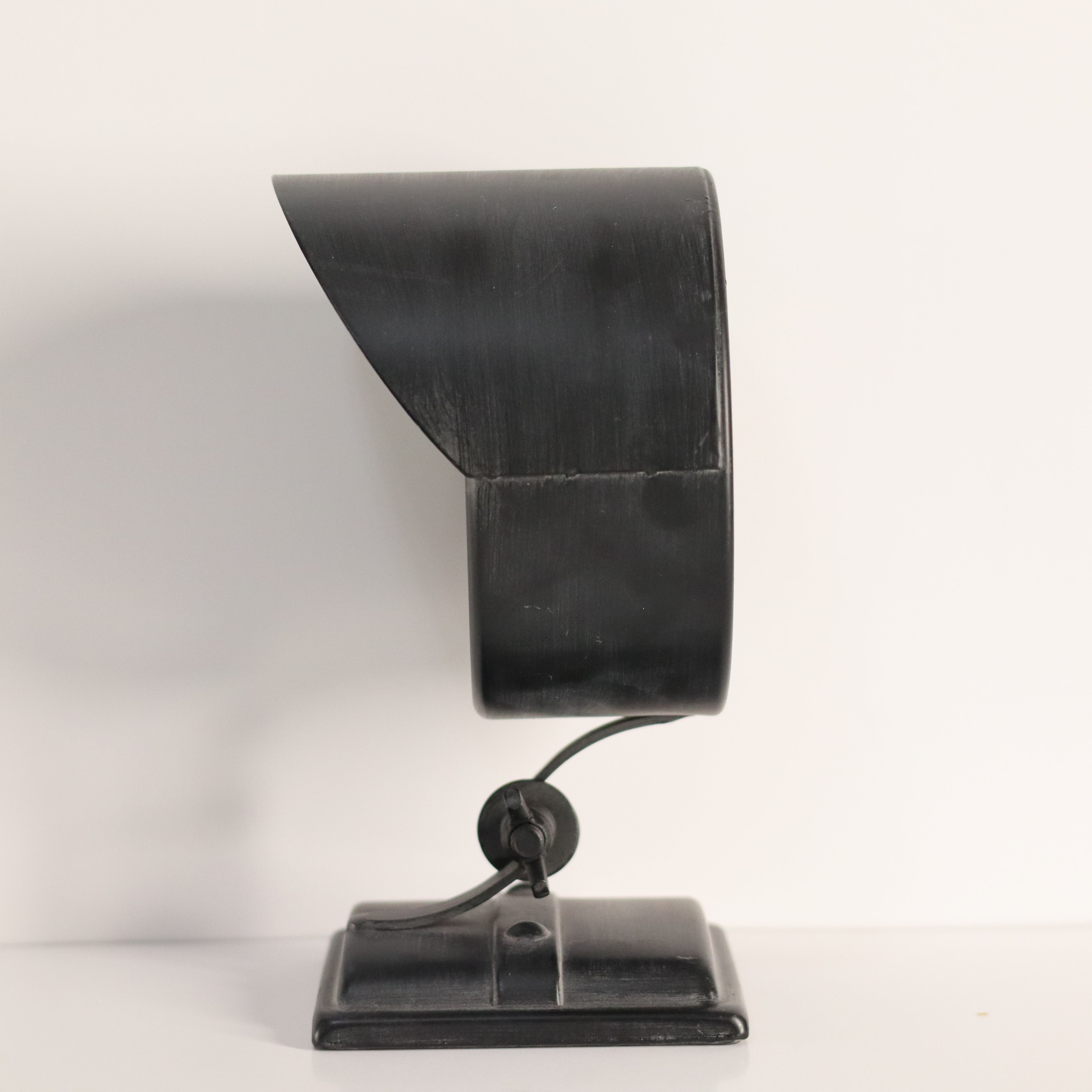 Black metal lamp with curved design on a white background