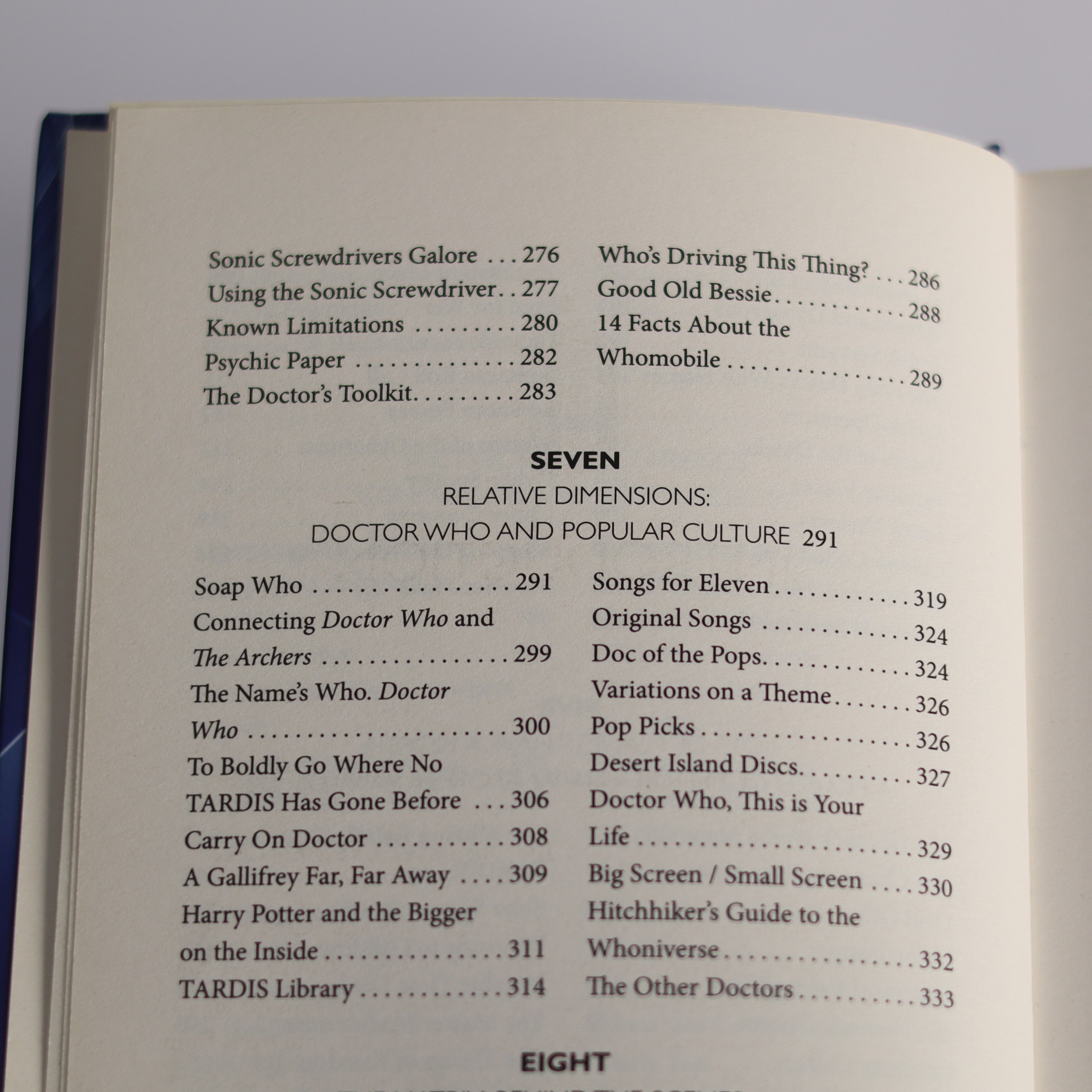 Open book showing a table of contents with chapter titles on a gray background