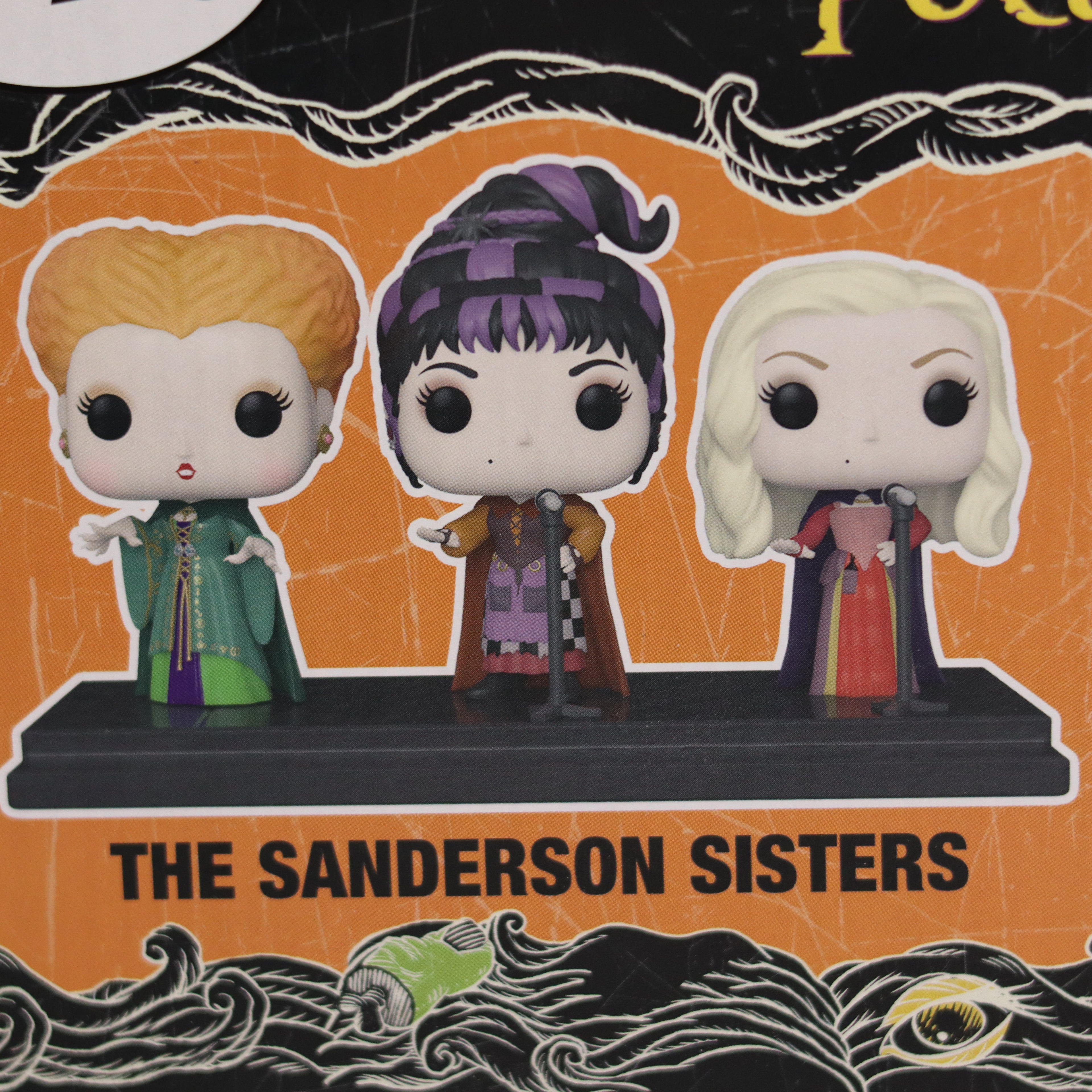 Funko Pop! figures of the Sanderson Sisters on an orange and black background