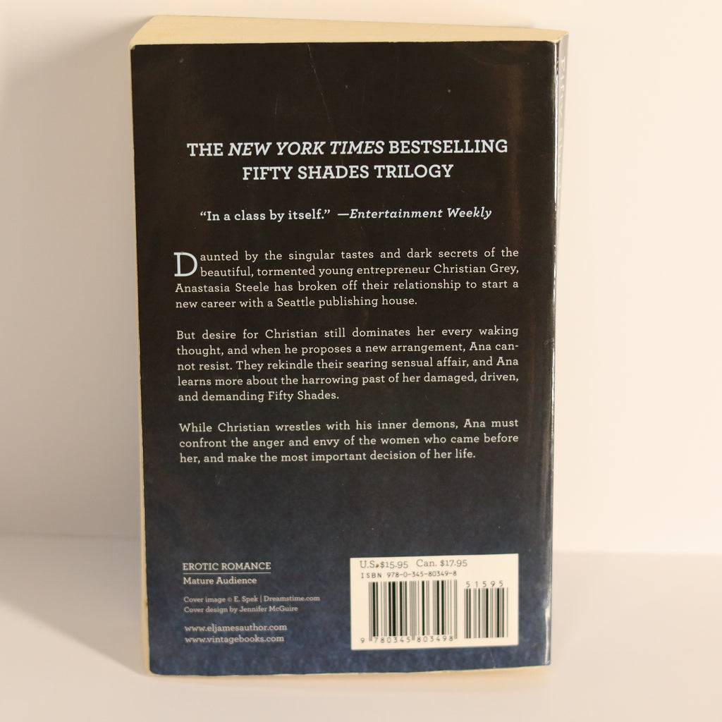 Back cover of a book with text and a barcode on a light background