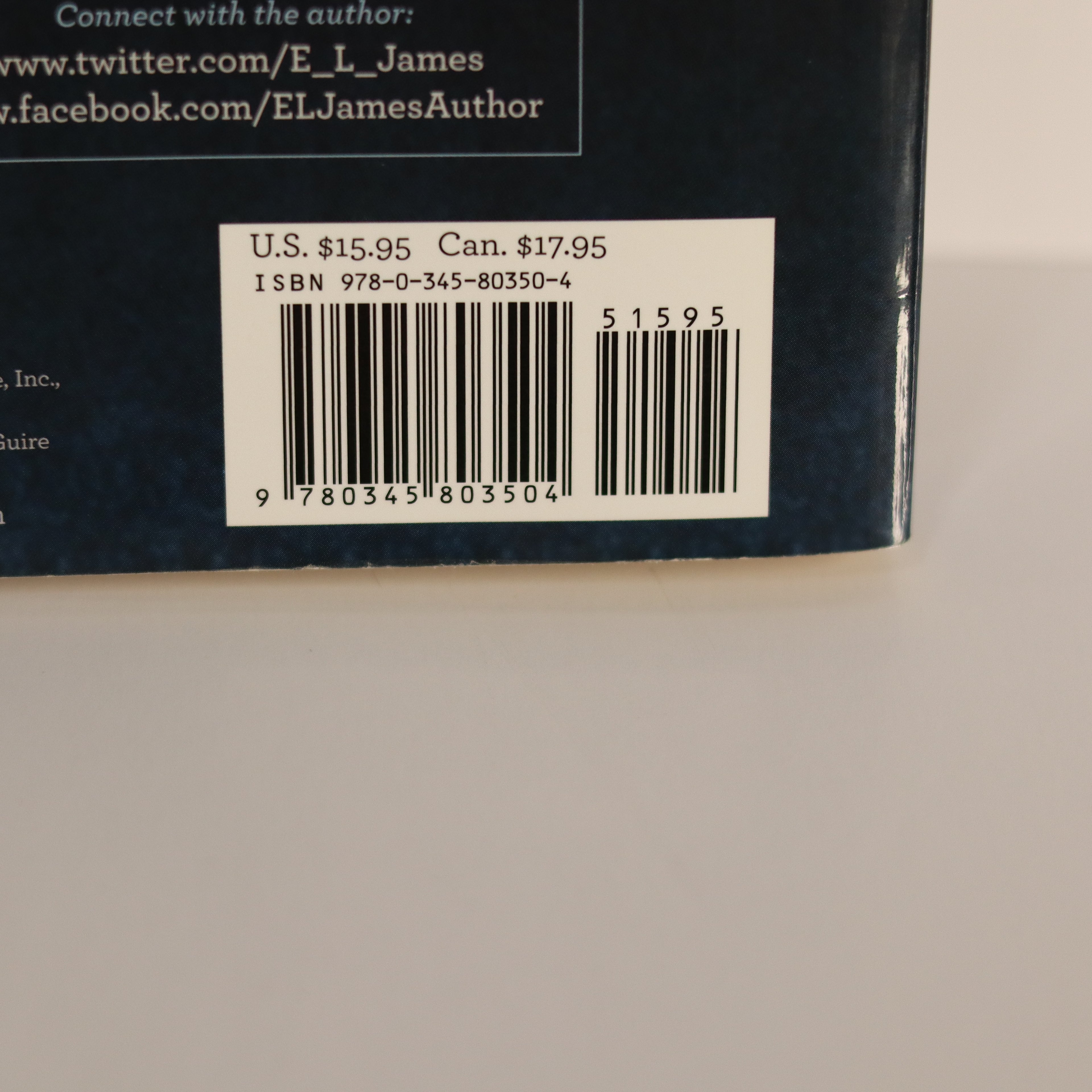 Back cover of a book with a barcode and pricing information on a beige background