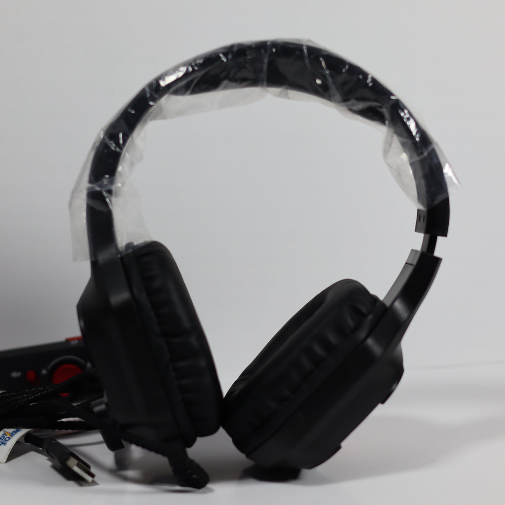 Black gaming headset with plastic wrap on a gray background