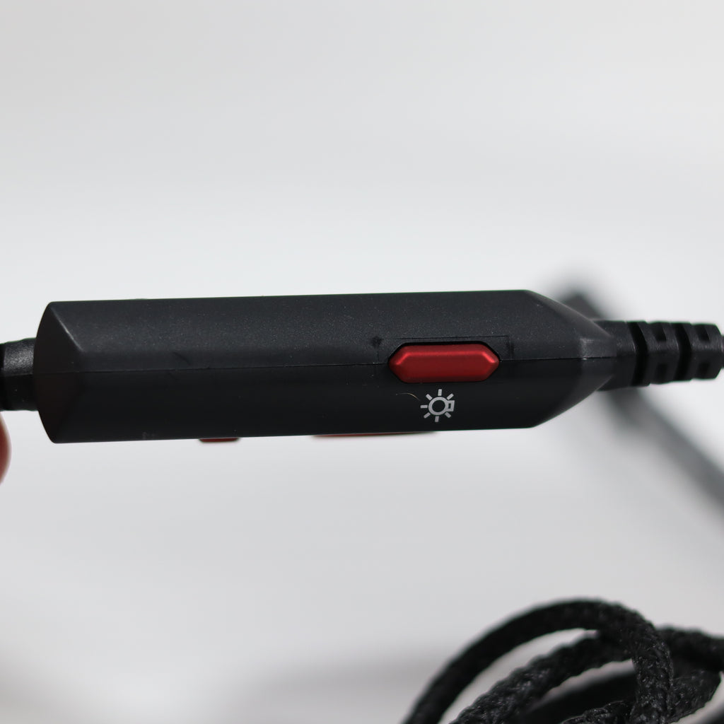 Black electronic device with a red button on a white background