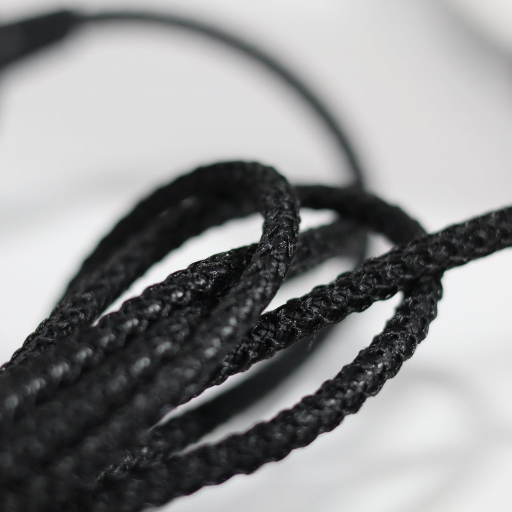 Close-up of black shoelaces on a light background