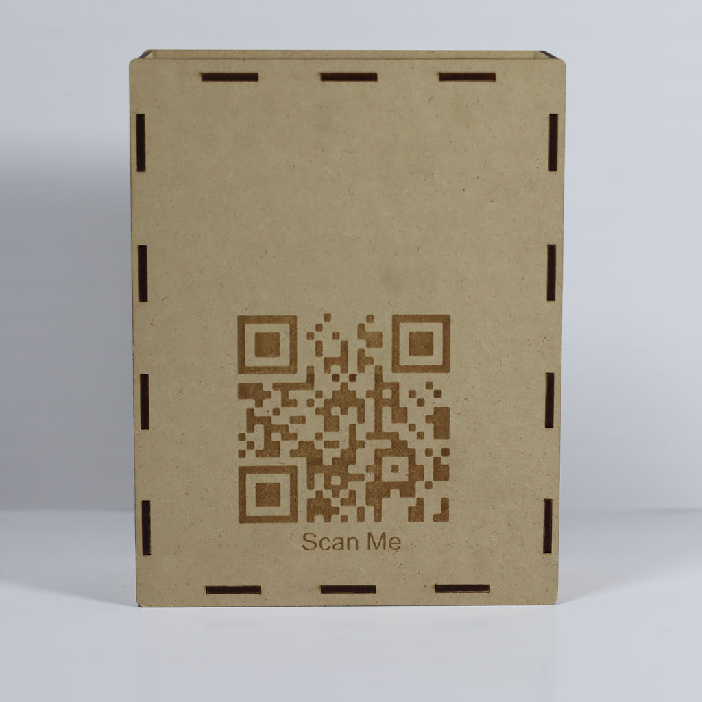 Brown cardboard box with a QR code and 'Scan Me' text on a light gray background