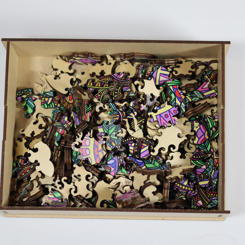 Colorful wooden puzzle pieces in a box on a white background