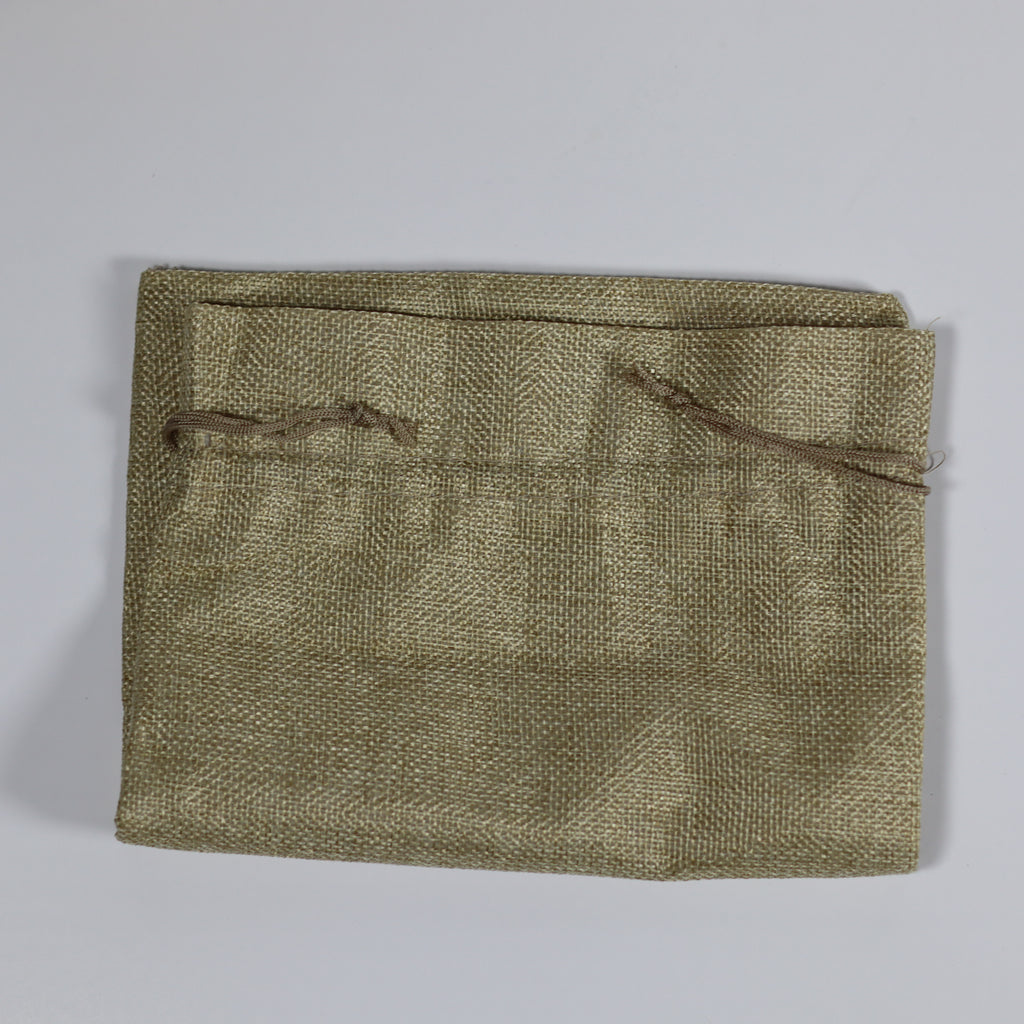 Textured green pouch on a gray background