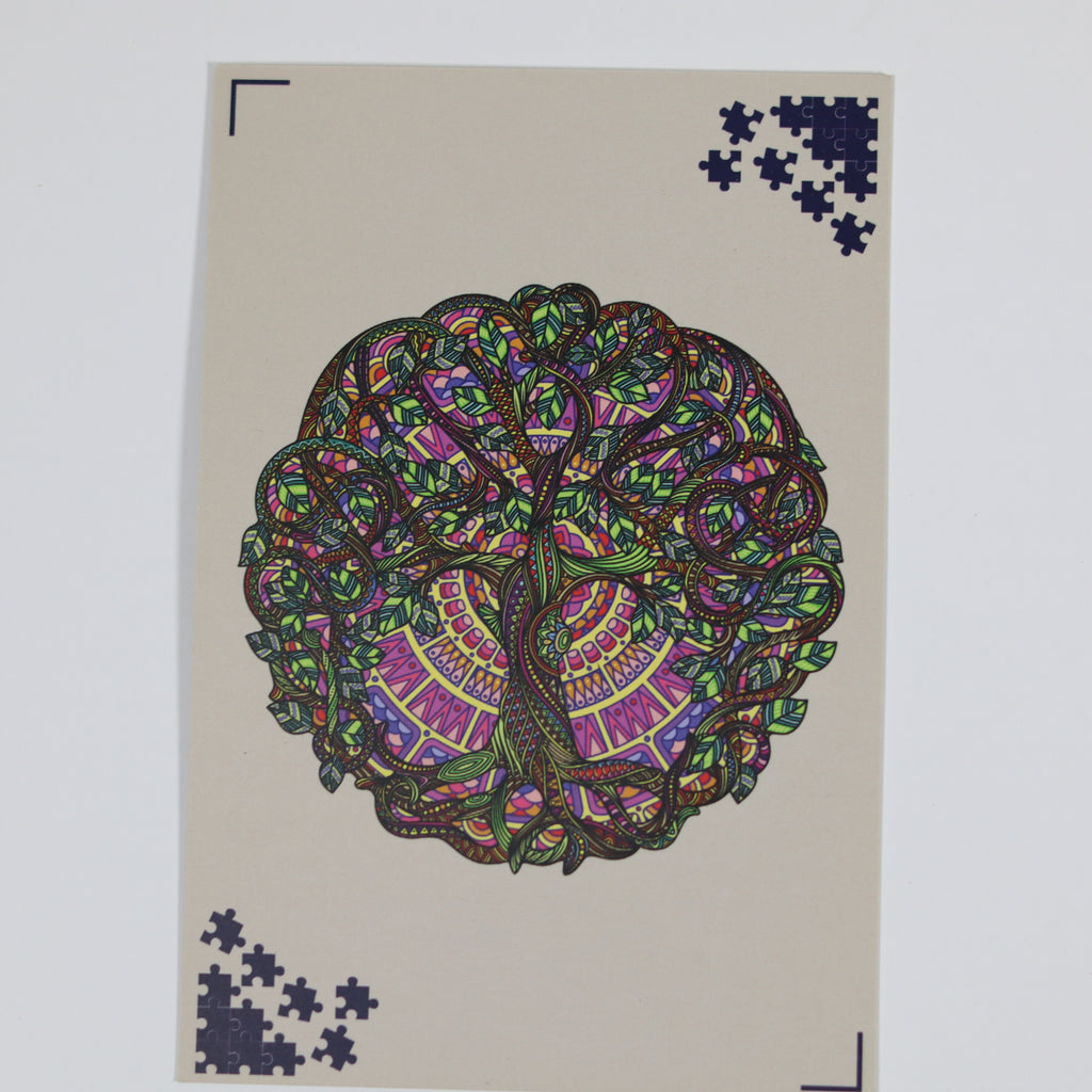 Colorful tree design on a beige card with scattered puzzle pieces.