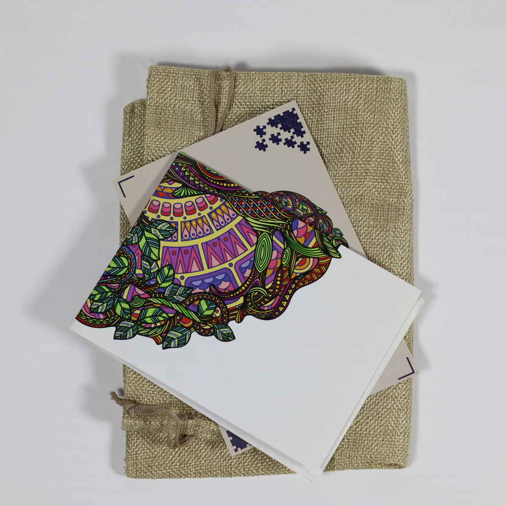 Colorful elephant design on a card with burlap fabric underneath