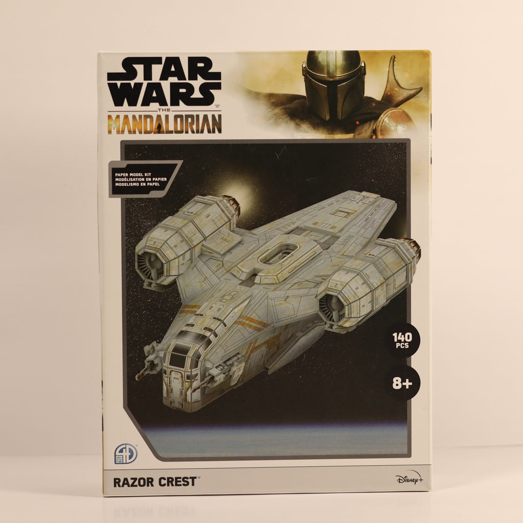 Star Wars The Mandalorian Razor Crest model kit packaging on a beige background