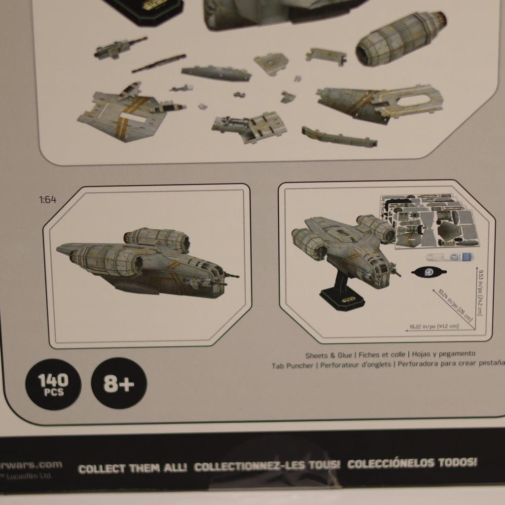 Model kit packaging with instructions and pieces displayed on a beige background