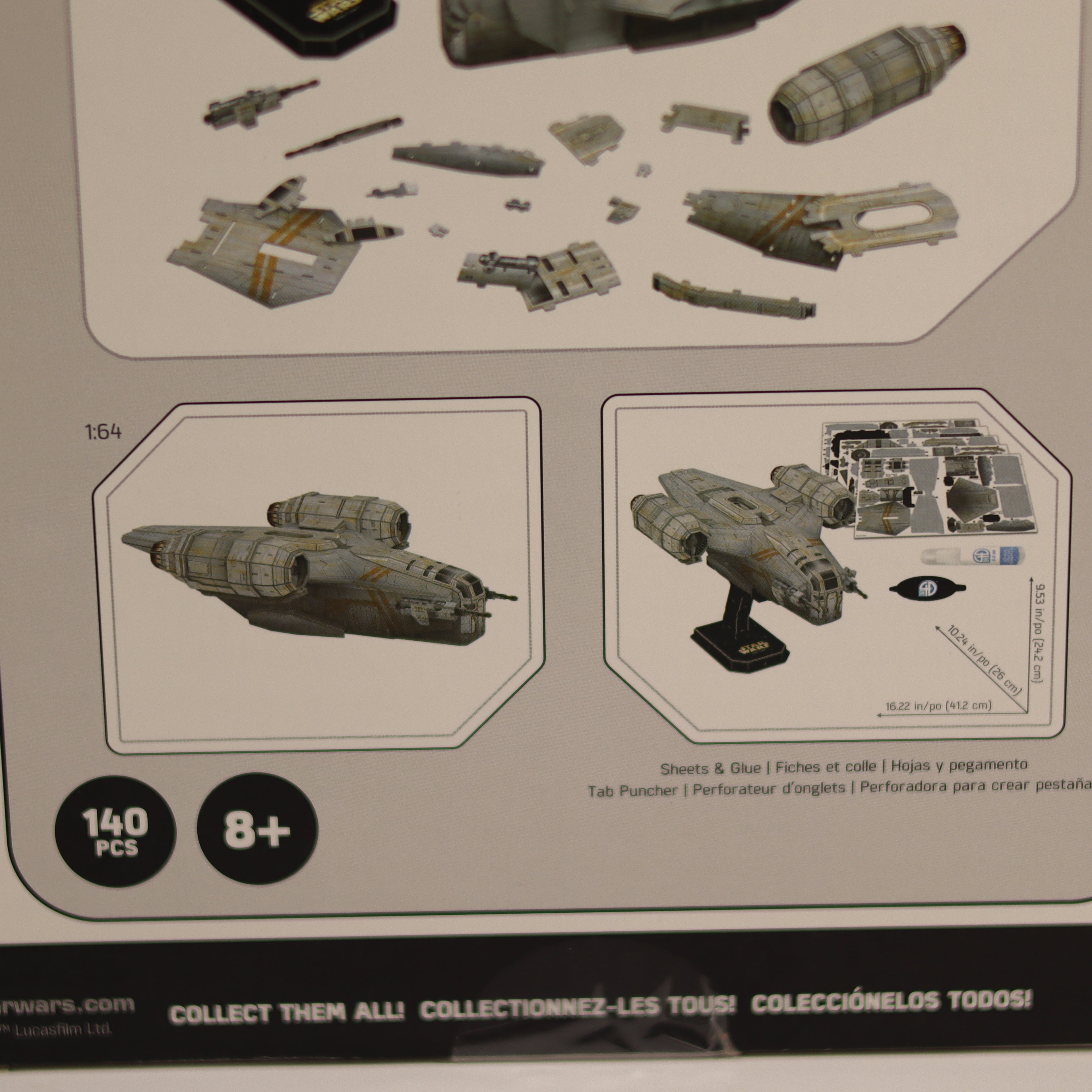 Model kit packaging with instructions and pieces displayed on a beige background