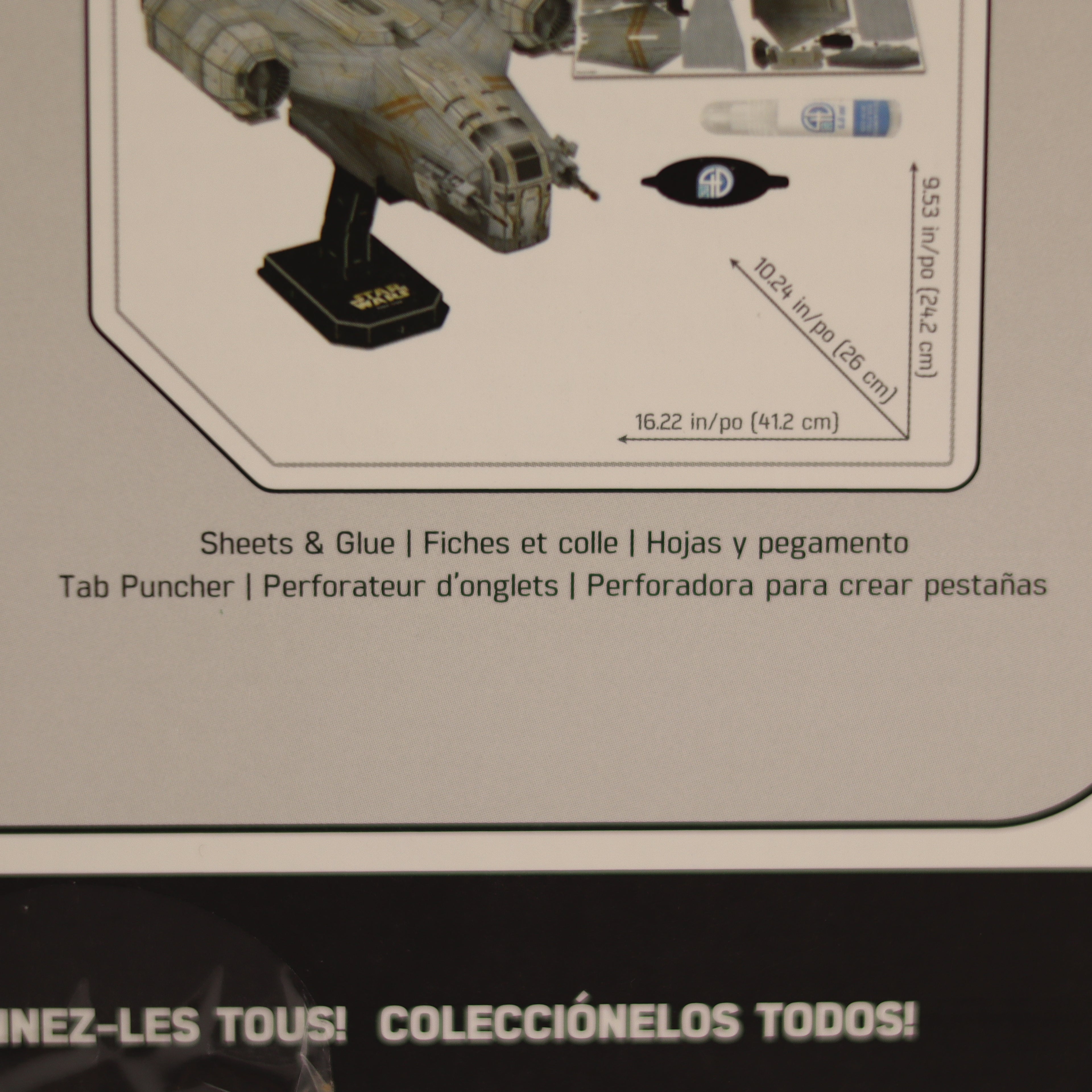 Model kit packaging with a spaceship model on a beige background
