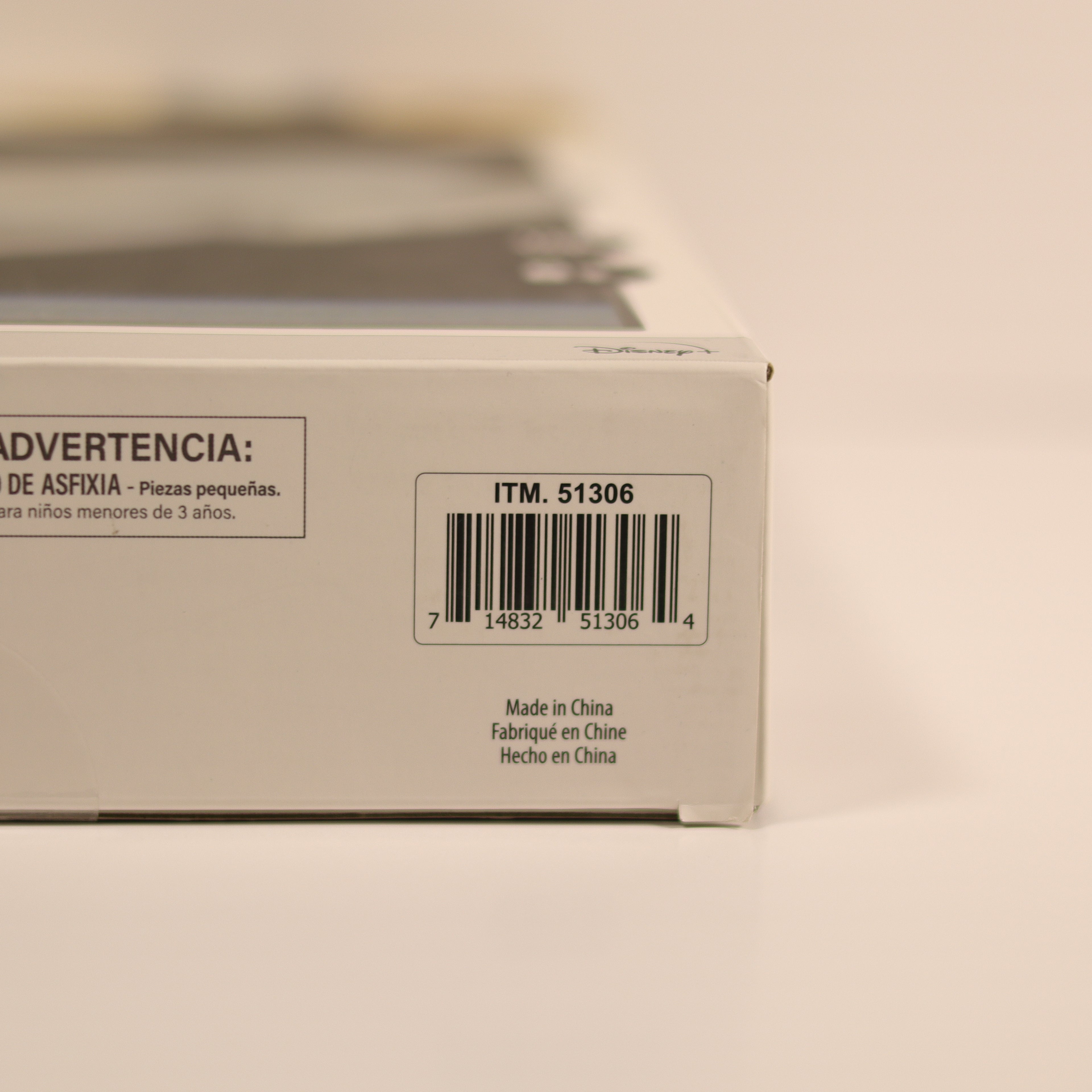 Product packaging with a warning label and barcode on a beige background
