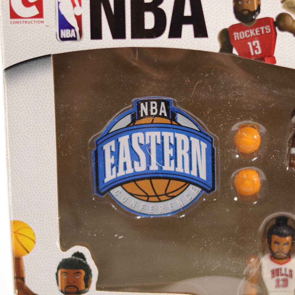 NBA toy set packaging with basketballs and player figures on a reflective surface.