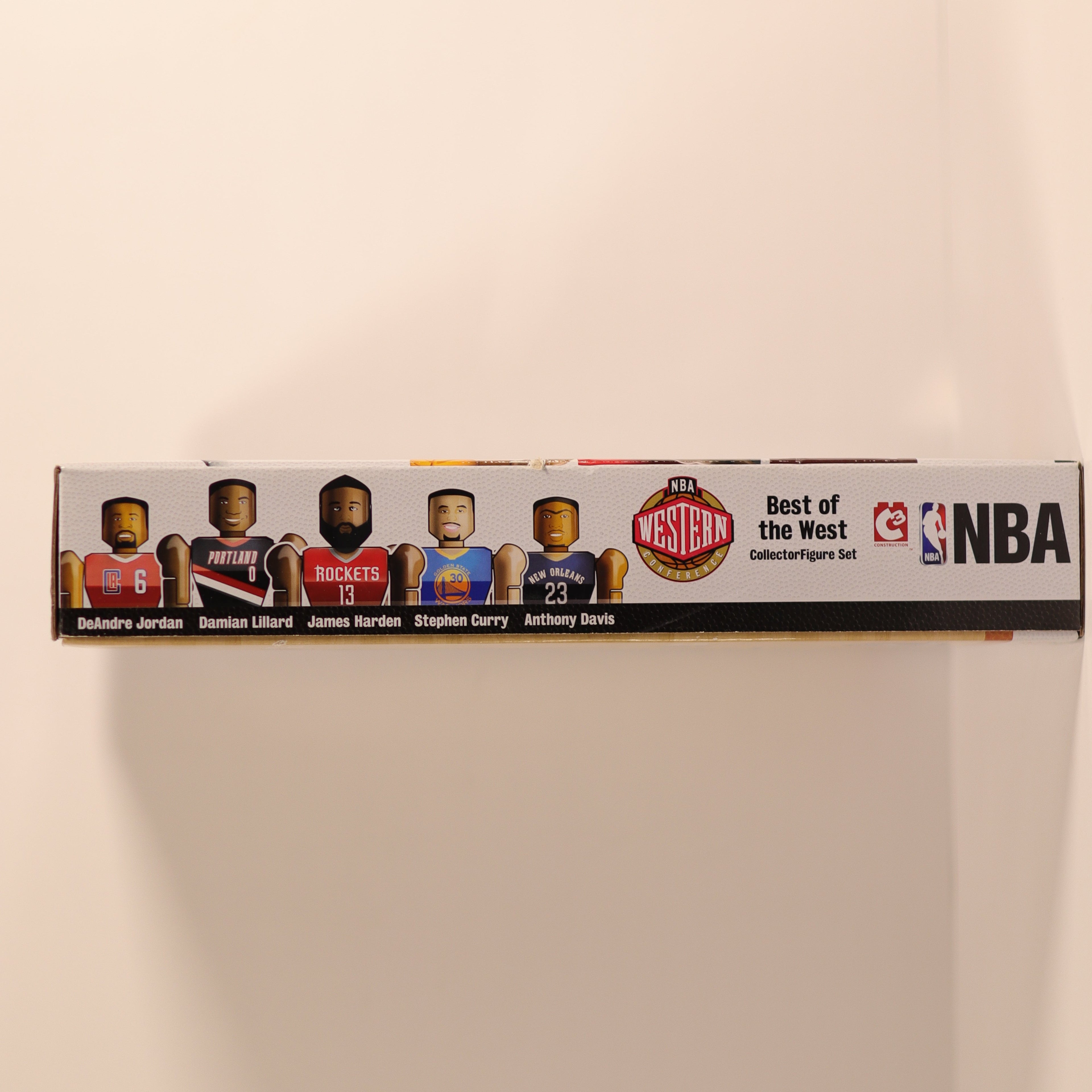 Box of NBA trading cards featuring player silhouettes on a beige background
