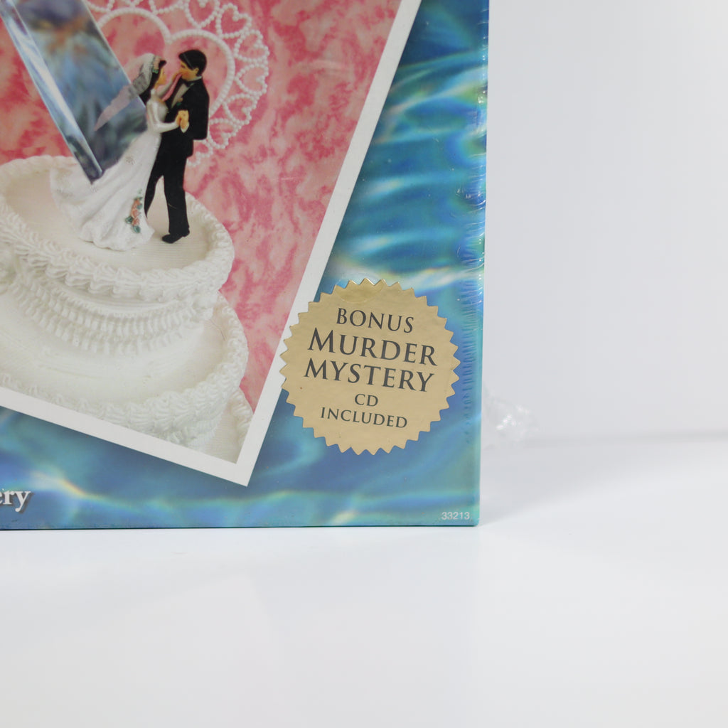 Product packaging with a wedding cake topper and 'Bonus Murder Mystery CD Included' label.