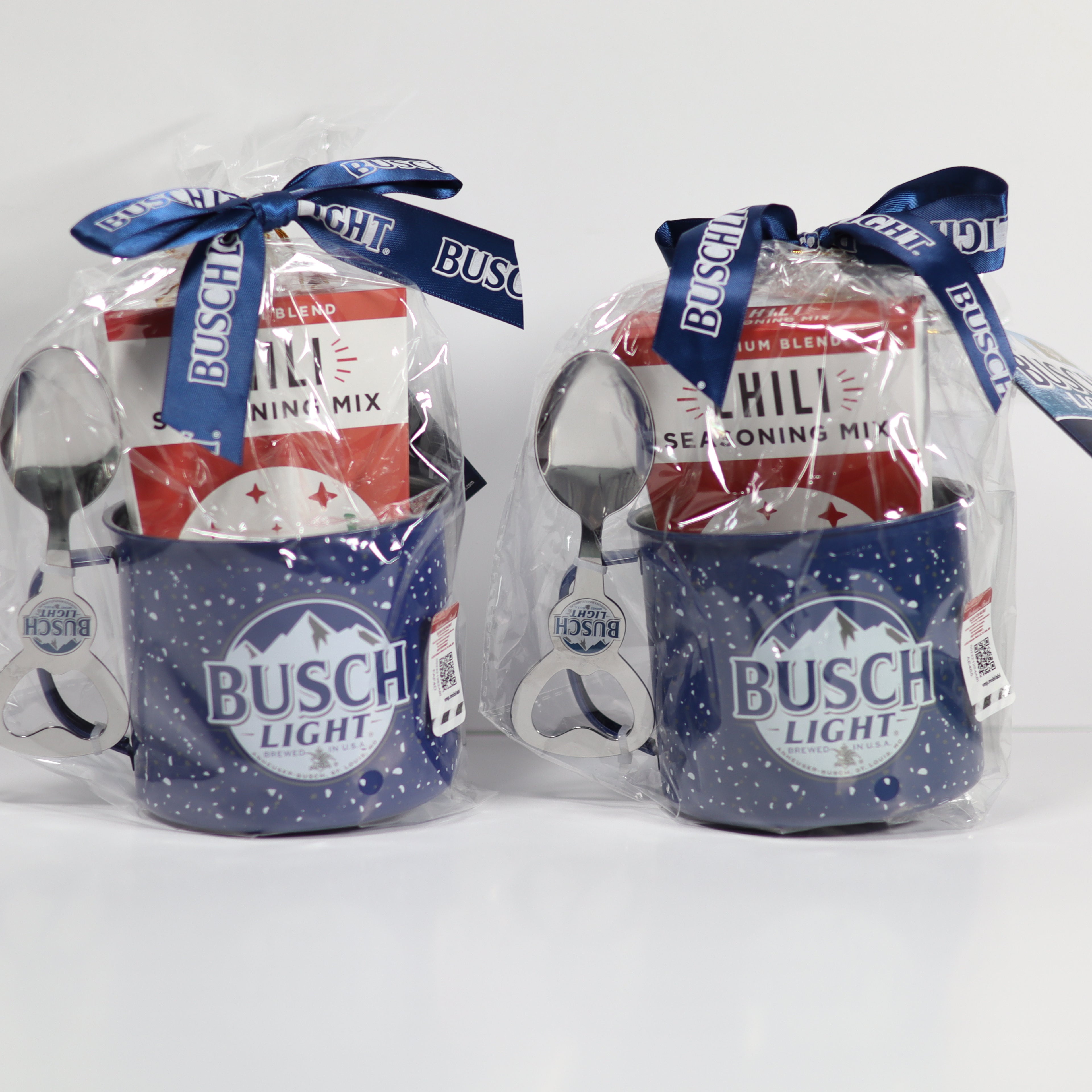 Two packages of Busch Light with spoons and seasoning mix on a white background