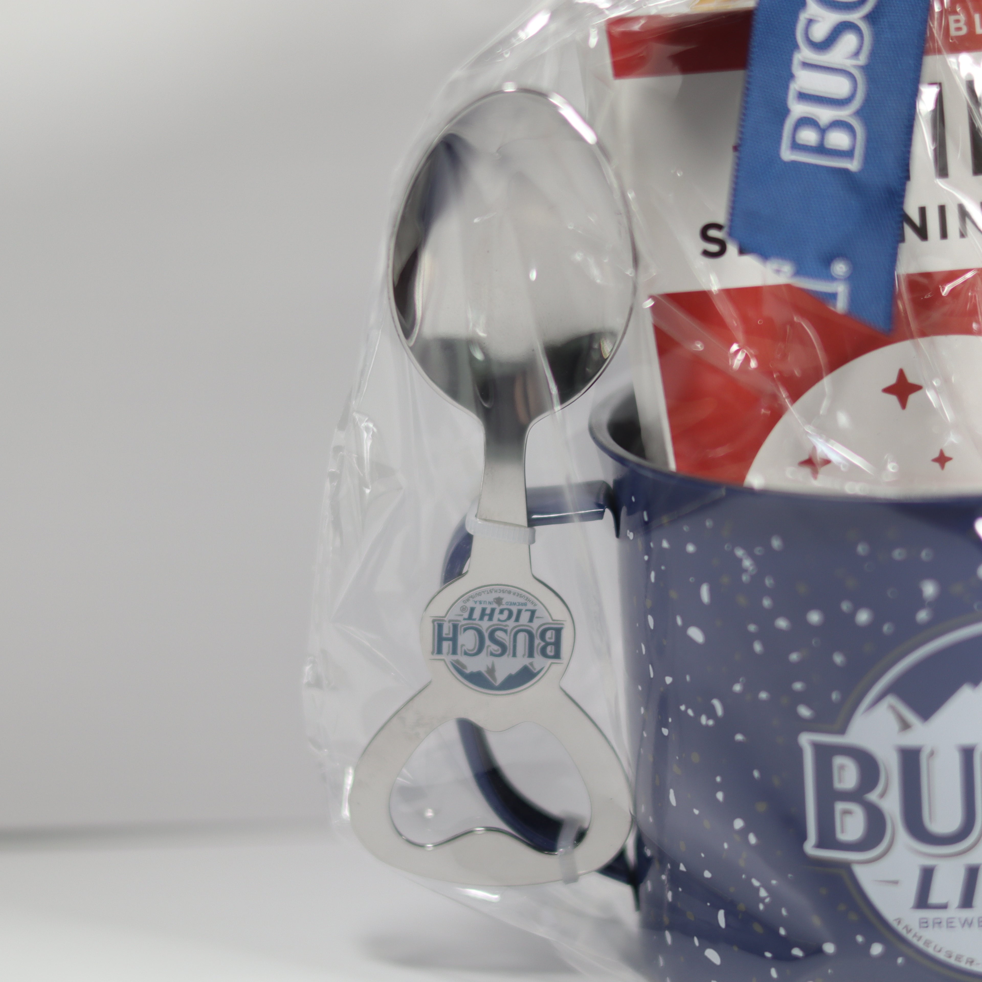 Bush's branded bottle opener and mug on a white background
