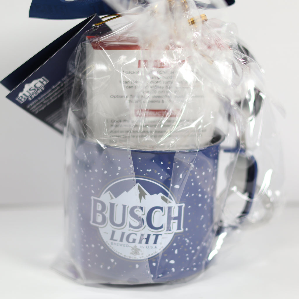 Blue mug with 'Busch Light' branding, partially wrapped in clear plastic on a white background.