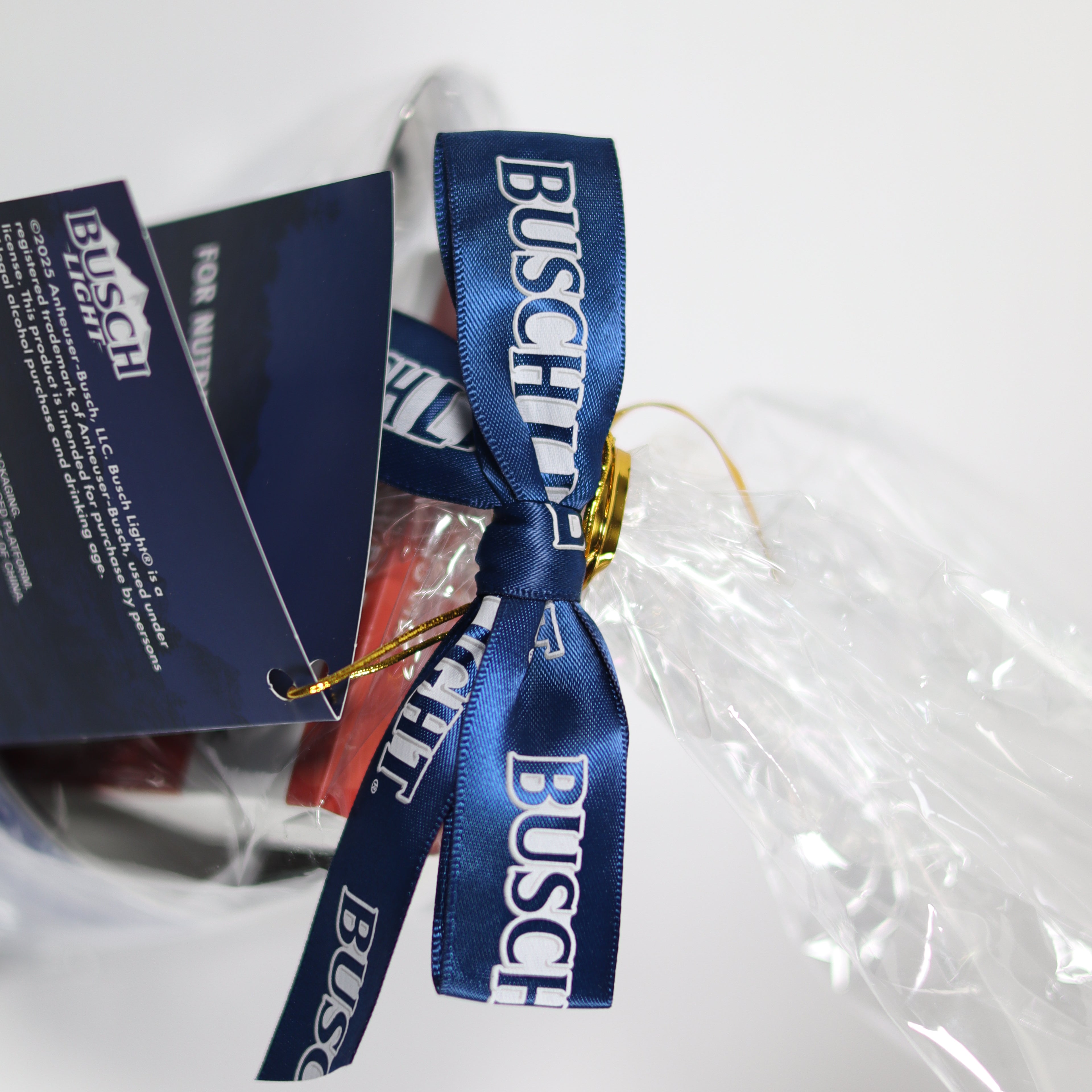Gift bag with Busch Light branding and a blue ribbon on a white background