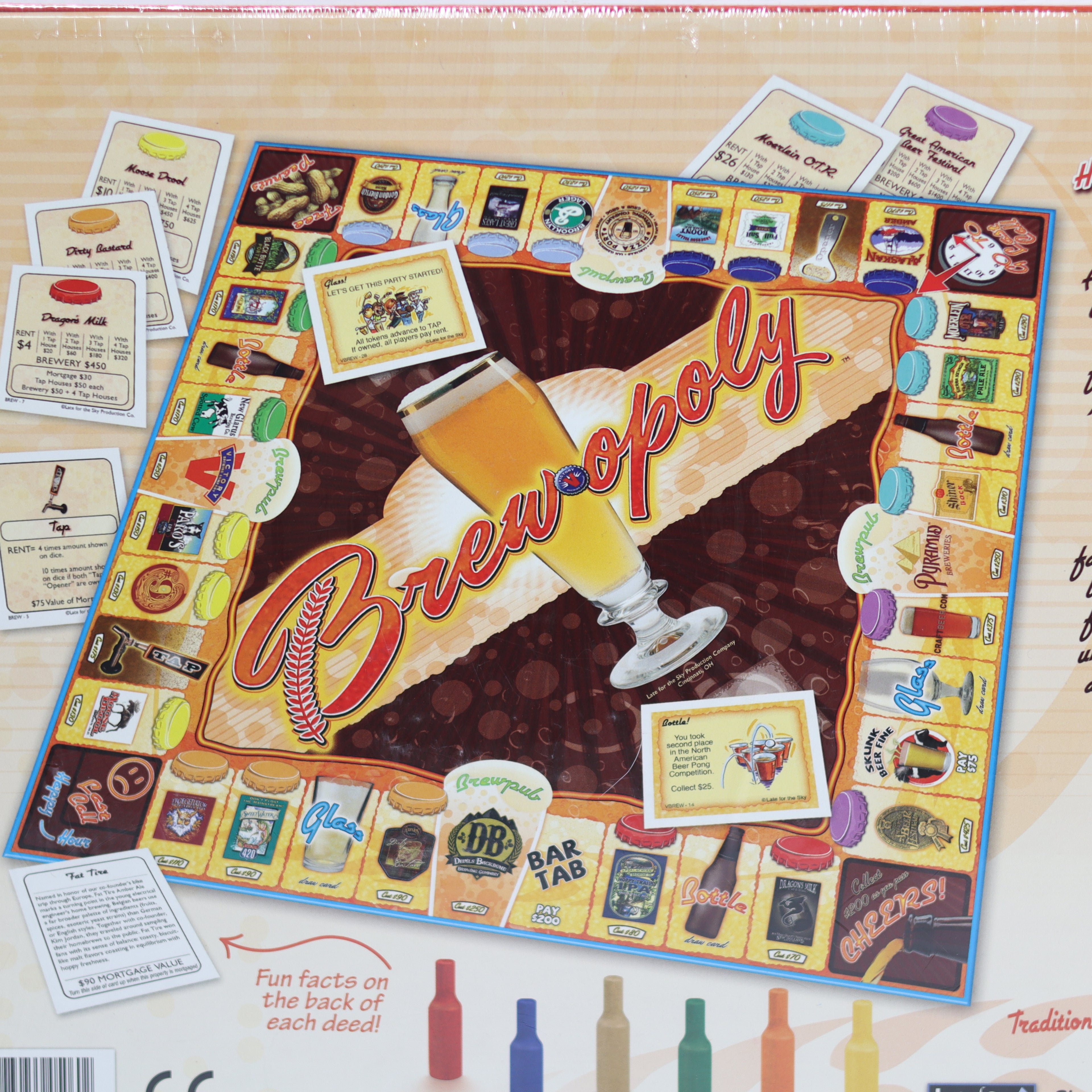Board game titled 'Brewopoly' with beer-themed design on a wooden surface.
