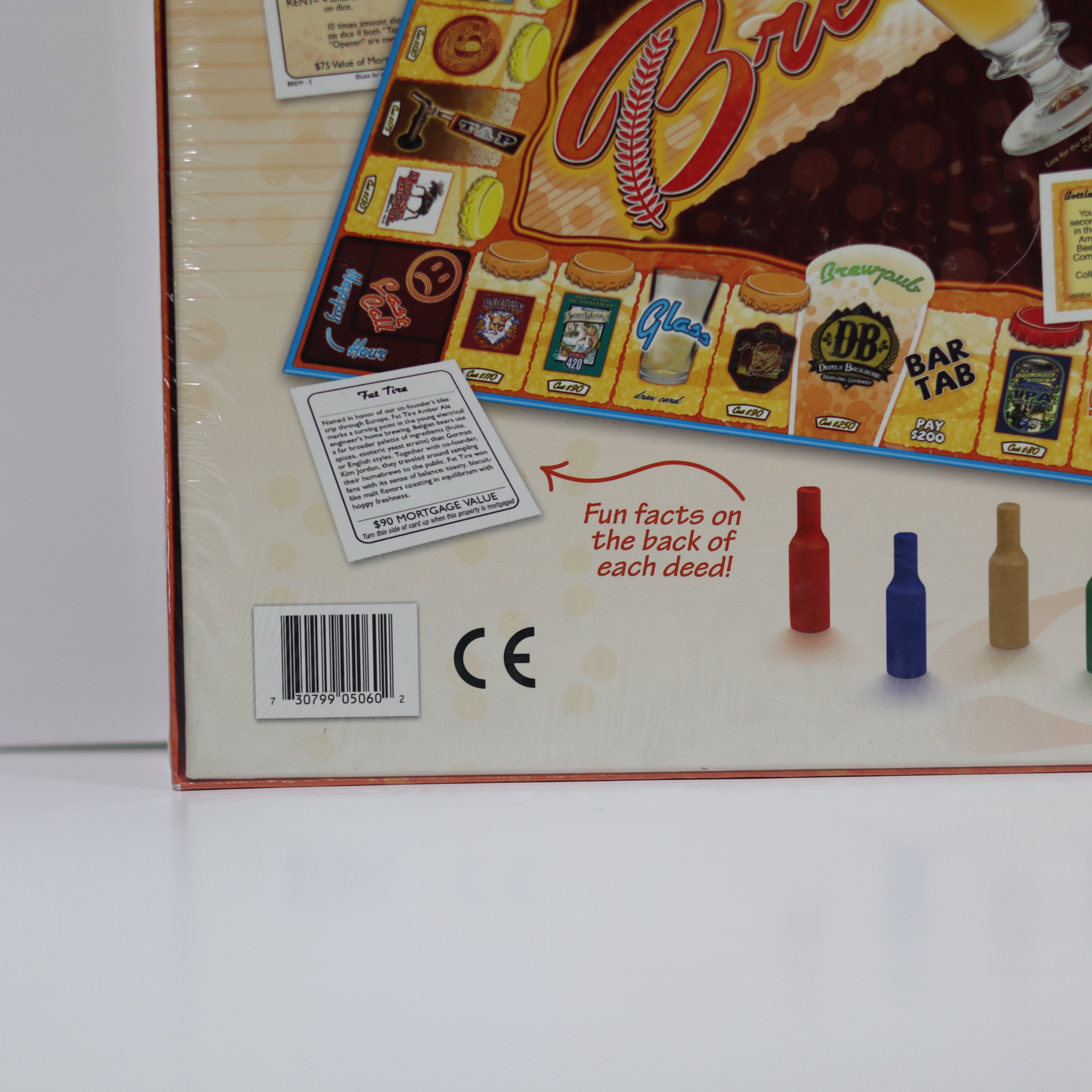 Close-up of a board game box with branding and product details.